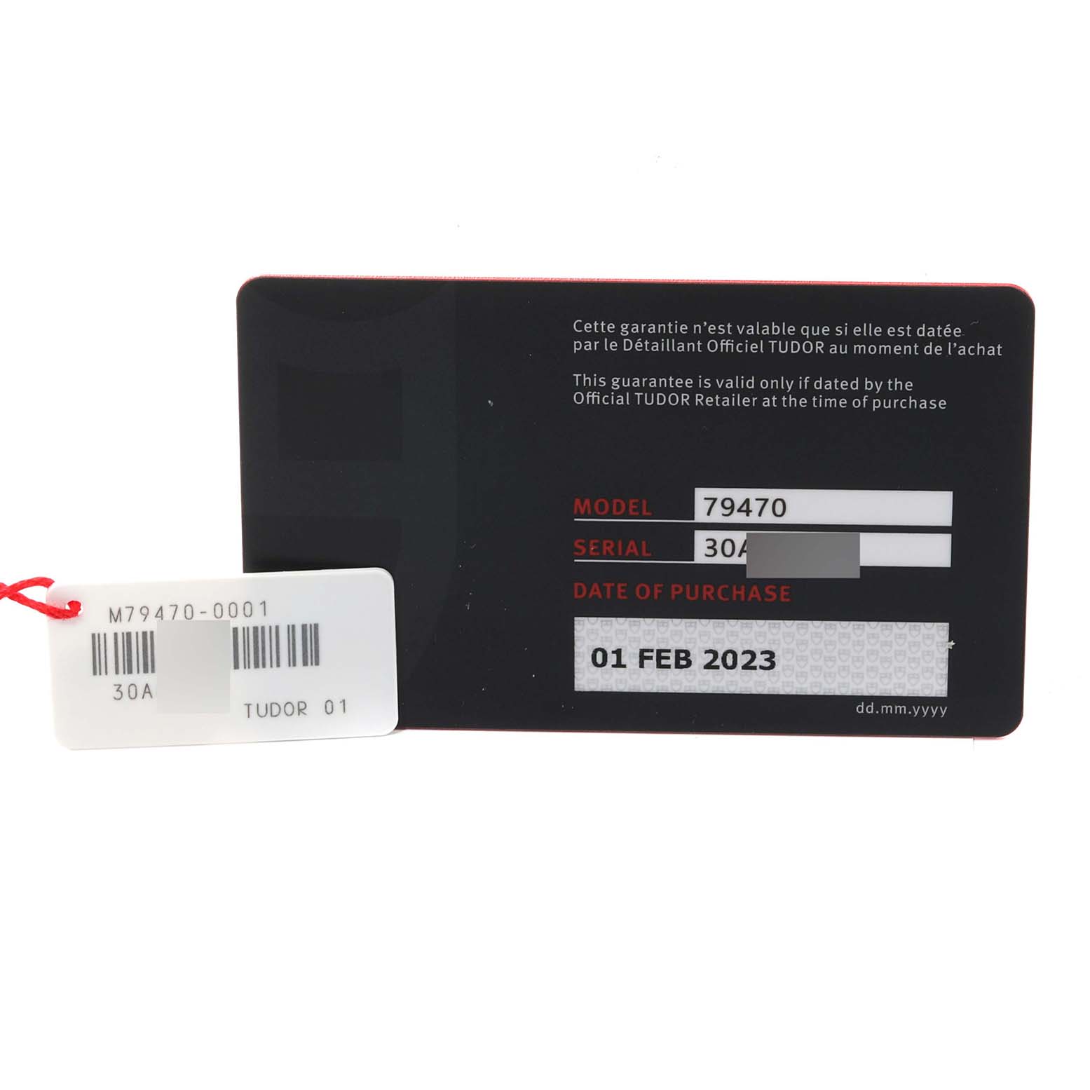 This image showcases a warranty card and a price tag for a Tudor Heritage Black Bay M79470-0001 Men
s Stainless Steel Black Dial M79470-0001 Men
s Stainless Steel Black Dial model 79470 watch.