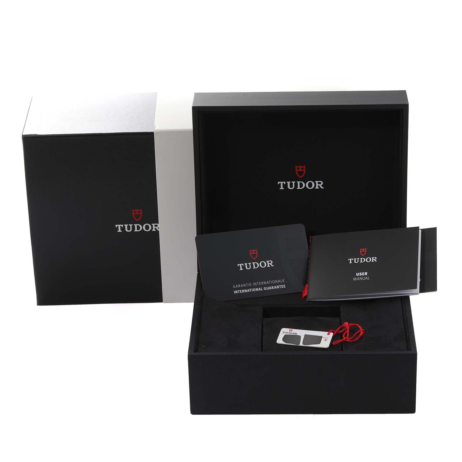 The image shows the packaging, user manual, international guarantee card, and a tag for the Tudor Heritage Black Bay M79470-0001 Men
s Stainless Steel Black Dial M79470-0001 Men
s Stainless Steel Black Dial watch.