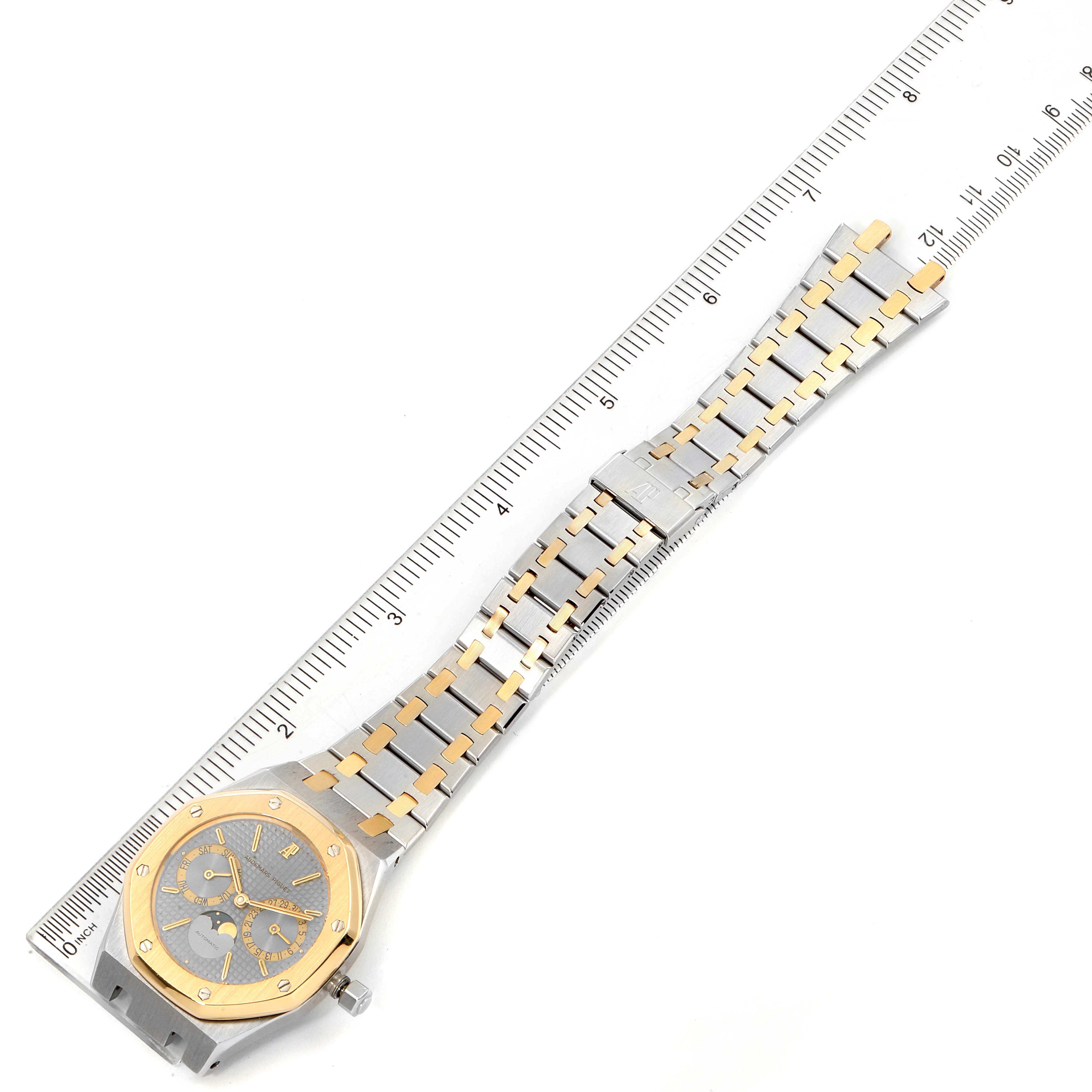 The image shows a top-down view of a Royal Oak model by Audemars Piguet, highlighting the watch face and metal bracelet.