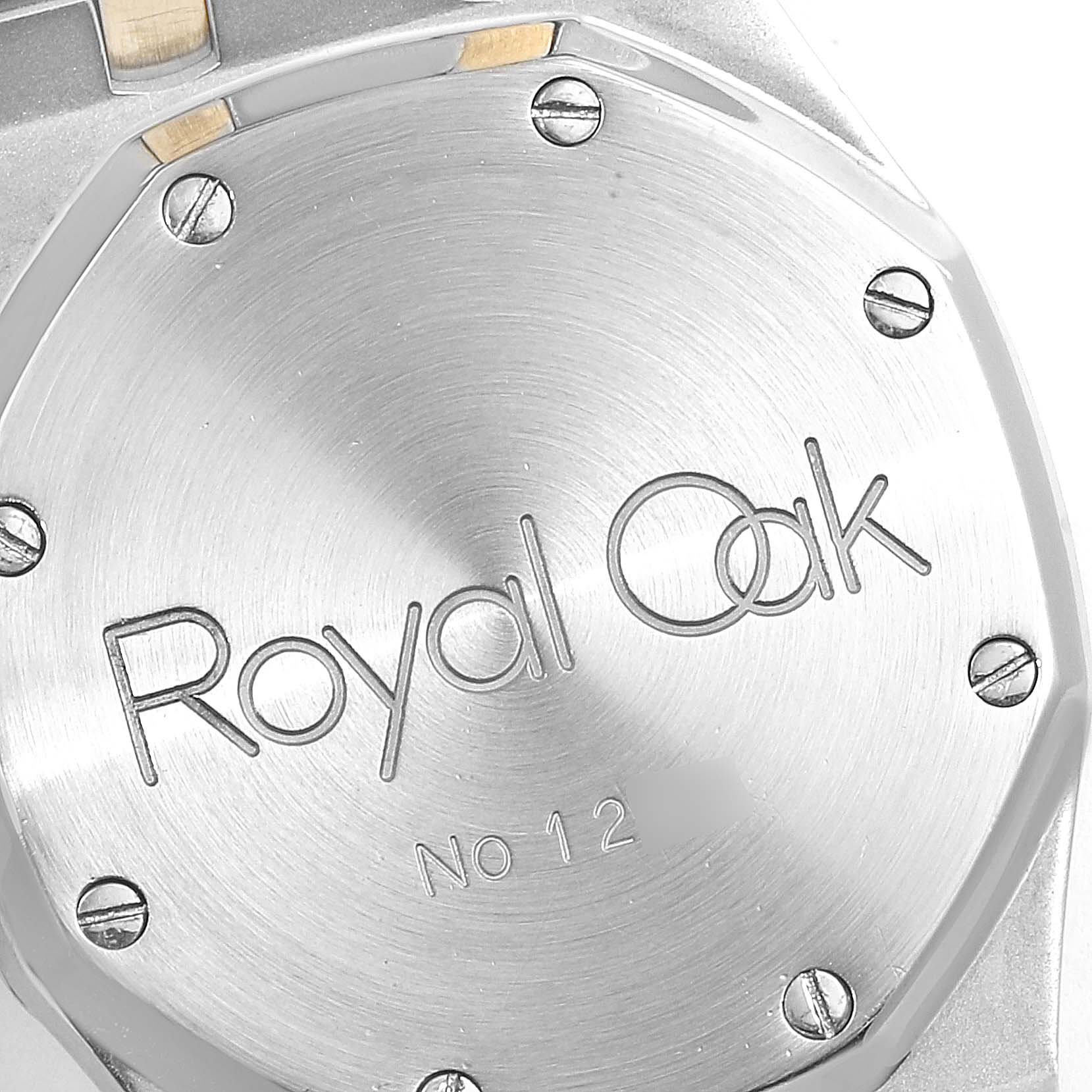 The image shows the back case of an Audemars Piguet Royal Oak 25594SA.O.0789SA.01 Men's Steel and Gold (two tone) Silver Dial 25594SA.O.0789SA.01 Men's Steel and Gold (two tone) Silver Dial watch with the model name engraved.