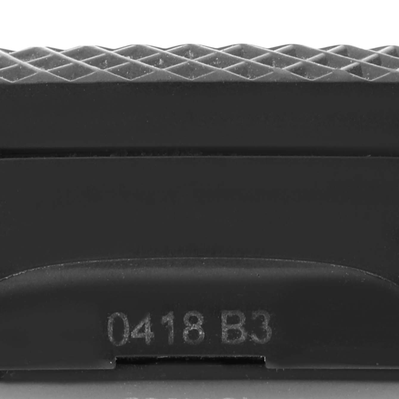 This image shows a close-up of the textured bezel and part of the casing of a Breitling Bentley XB0613 Men's Ceramic Blue Dial XB0613 Men's Ceramic Blue Dial model watch, with a serial number visible.