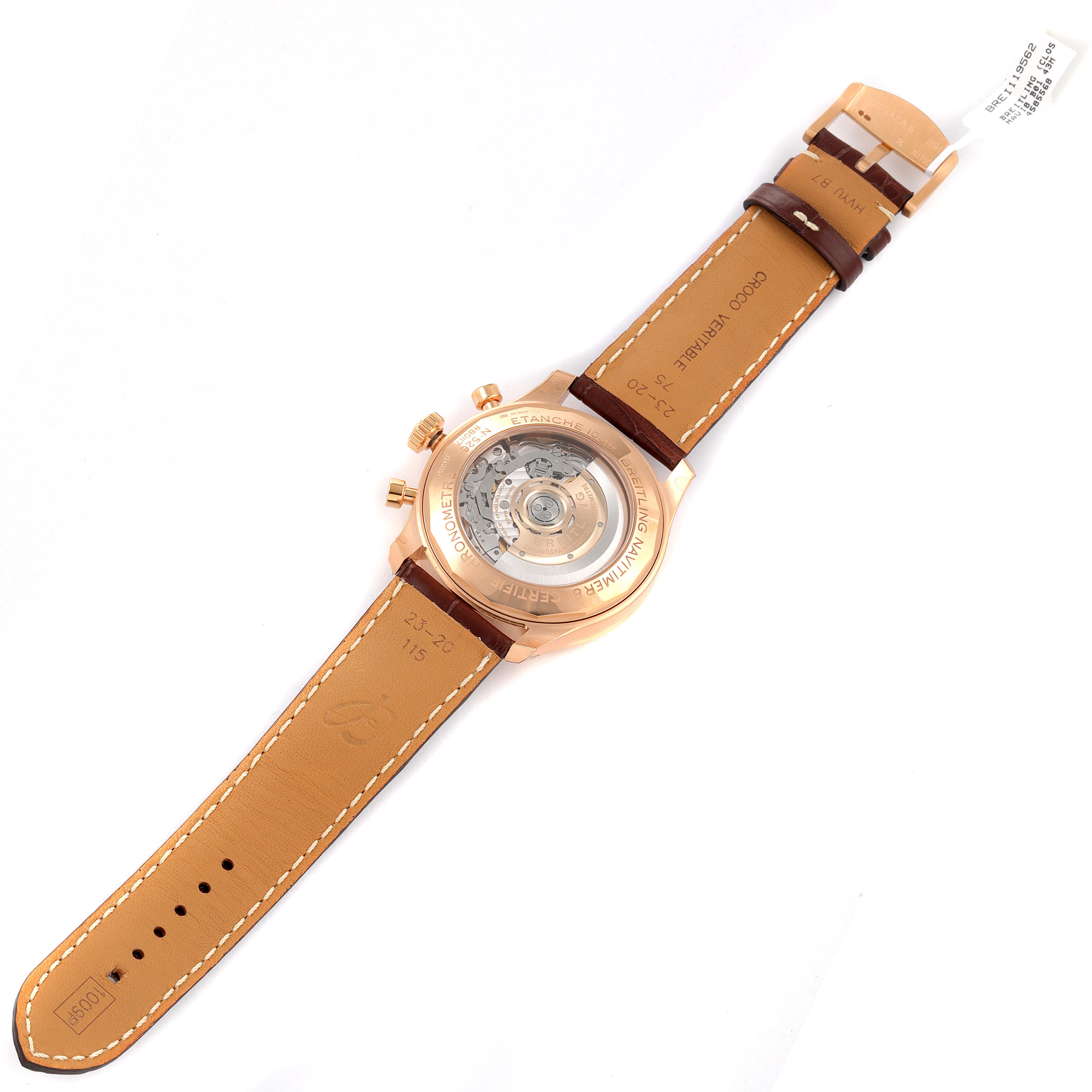 The image shows the back view of a Breitling Navitimer watch, displaying its open case back and leather strap.