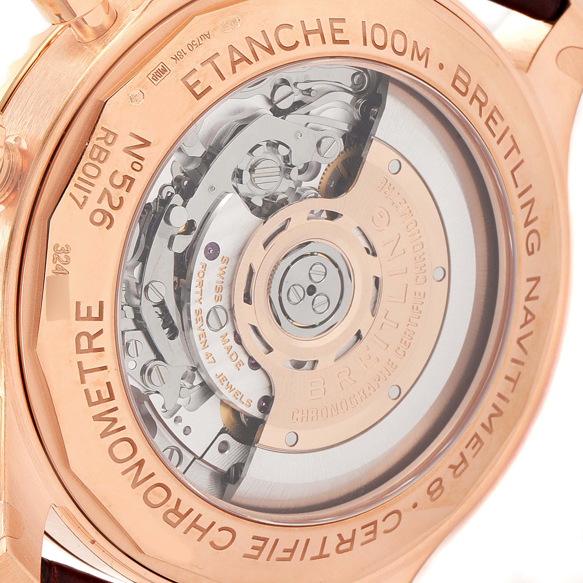 This image shows the back case of a Breitling Navitimer, highlighting the movement and engravings.