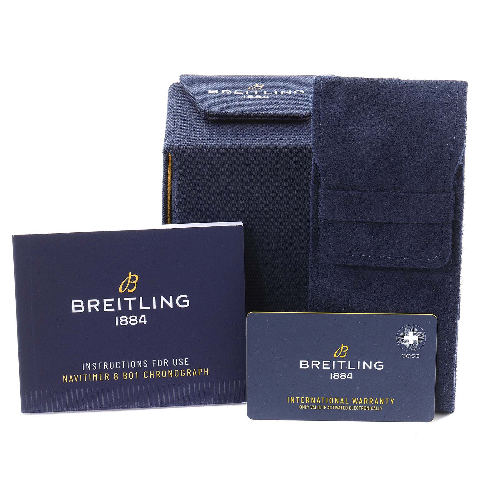 The image shows the packaging and accessories for the Breitling Navitimer watch, including a box, instruction manual, and warranty card.
