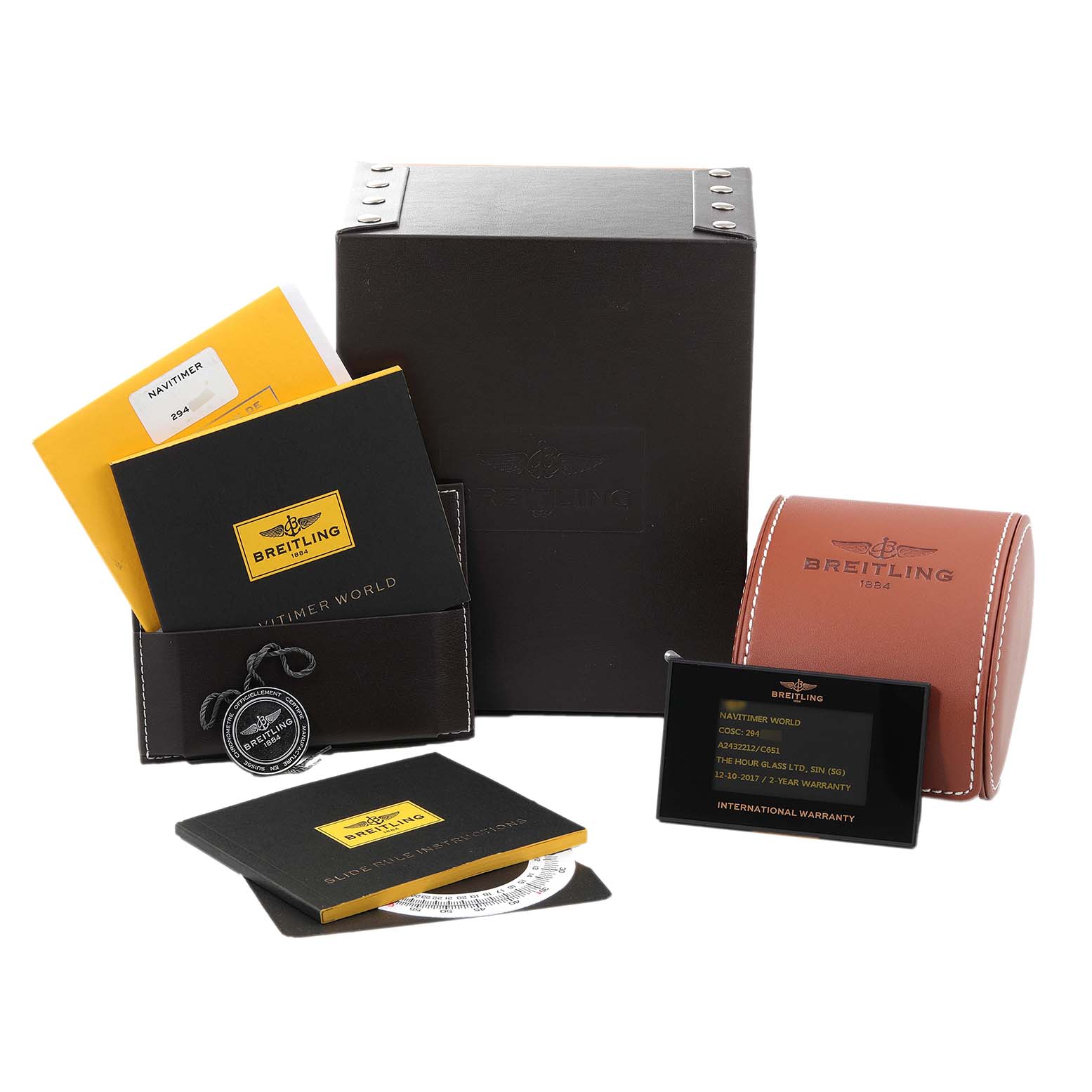 The image shows Breitling Navitimer A24322 Men
s Stainless Steel Blue Dial A24322 Men
s Stainless Steel Blue Dial watch accessories including boxes, booklets, a tag, and an international warranty card.