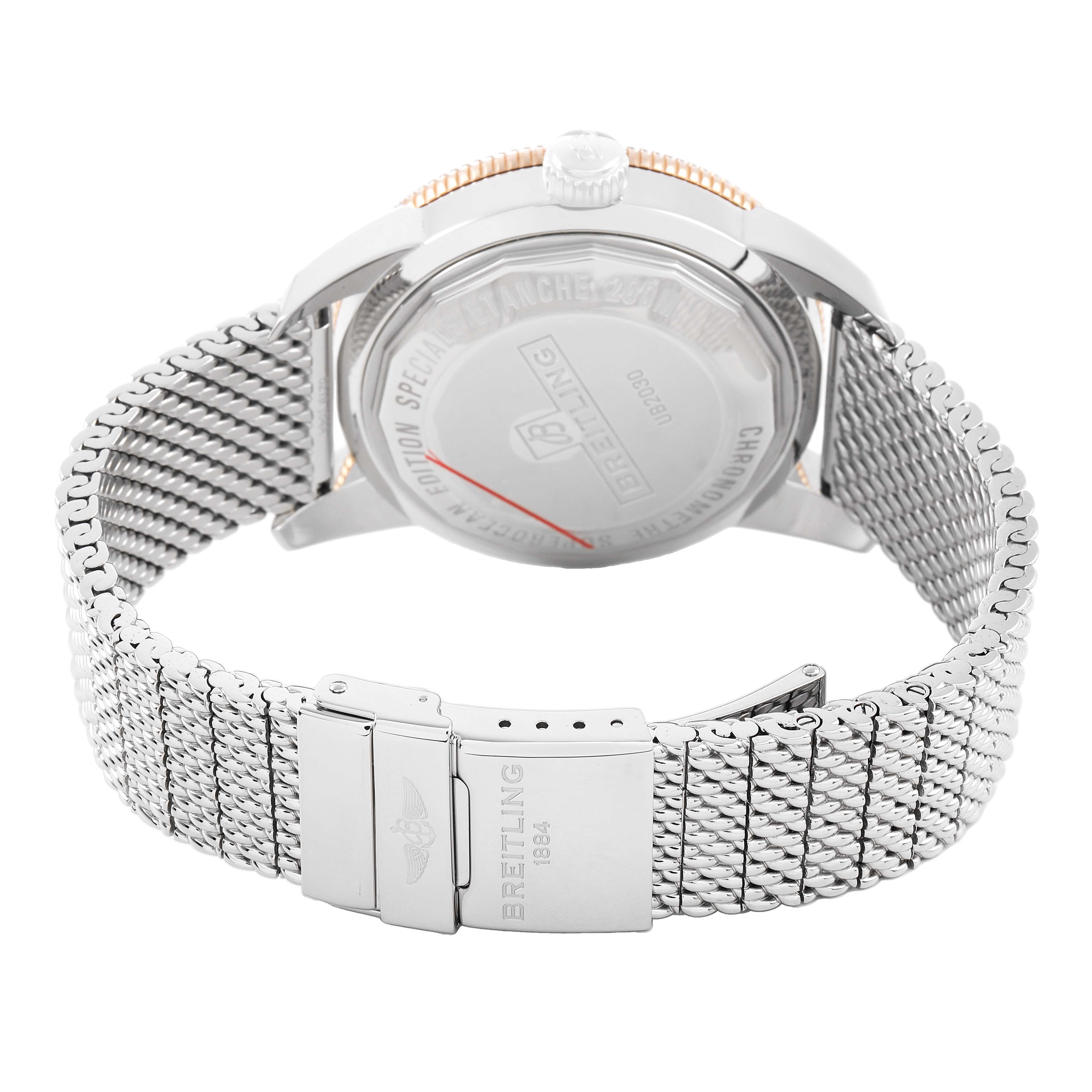 The Breitling Superocean UB2030 Men's Stainless Steel Black Dial watch is shown from the back, highlighting the case back, crown, and mesh bracelet.