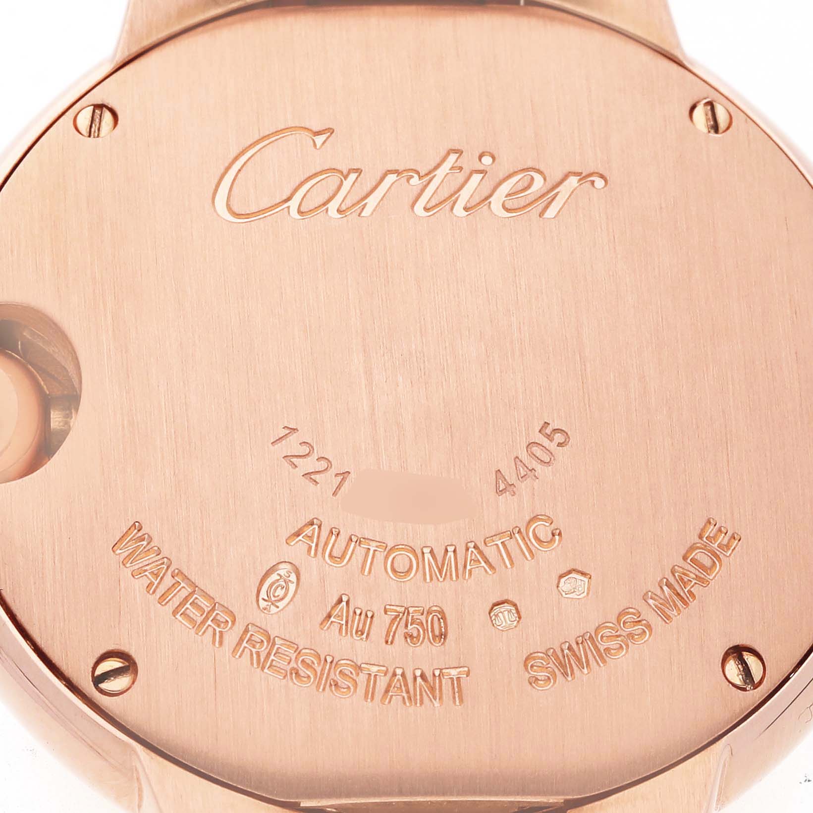 The image shows the back case of a Ballon Bleu by Cartier, highlighting engravings and screws.