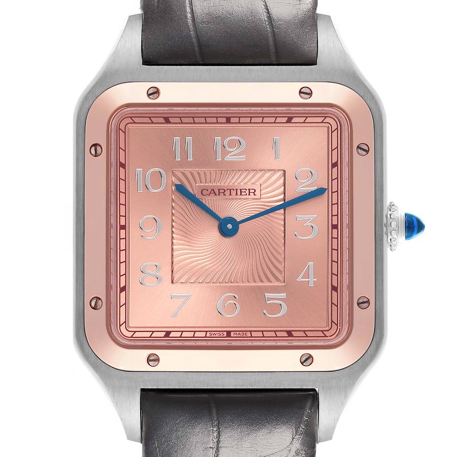 The Cartier Santos Dumont watch is shown from the front, highlighting its square face, pink dial, and blue hands.