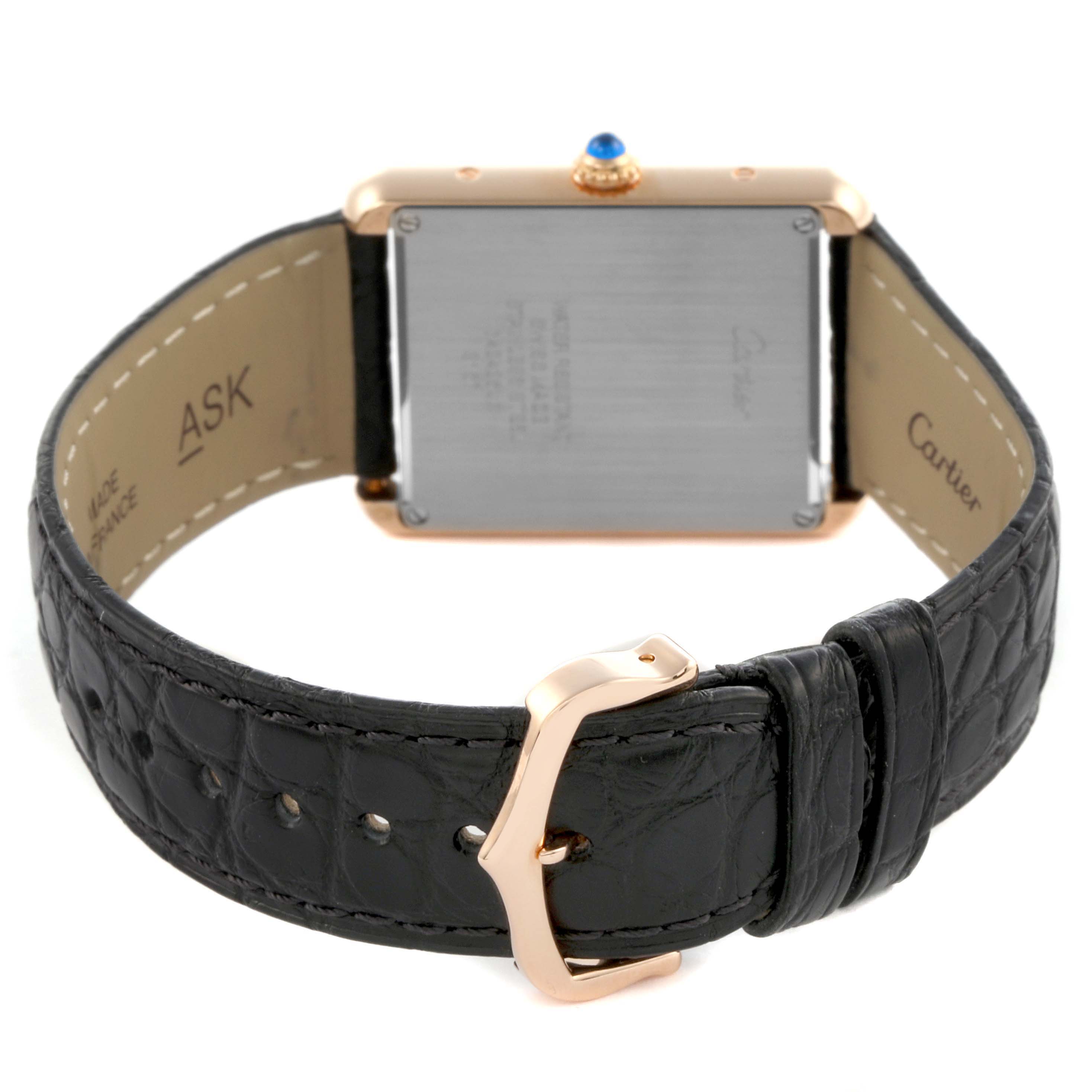 The image shows the back of a Cartier Tank Solo W5200025 Men's Yellow Gold Silver Dial W5200025 Men's Yellow Gold Silver Dial watch, highlighting the case back, black leather strap, and gold buckle.