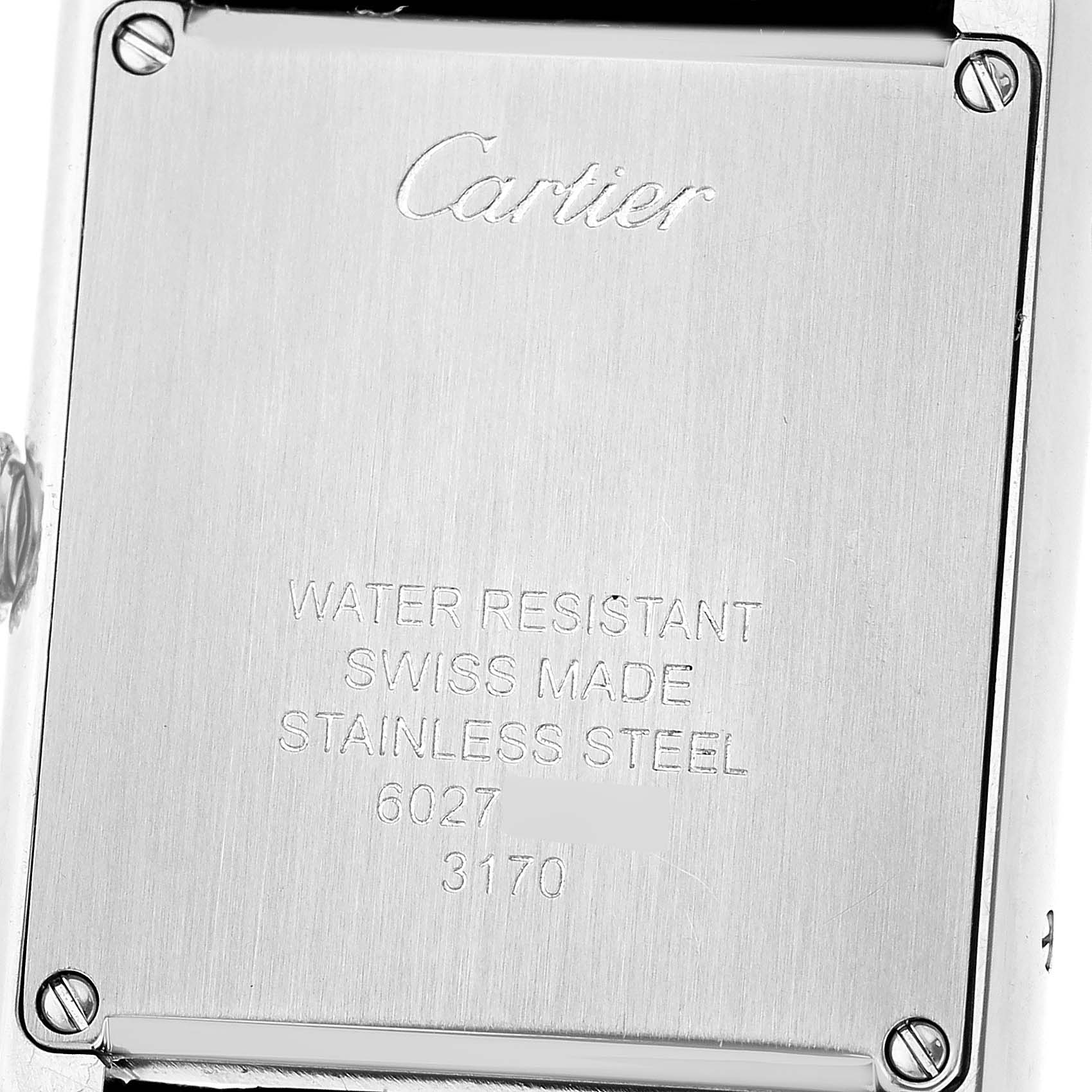 The image shows the back case of the Cartier Tank Solo WSTA0030 Women's Stainless Steel Silver Dial watch, displaying engraved details and screws at the corners.
