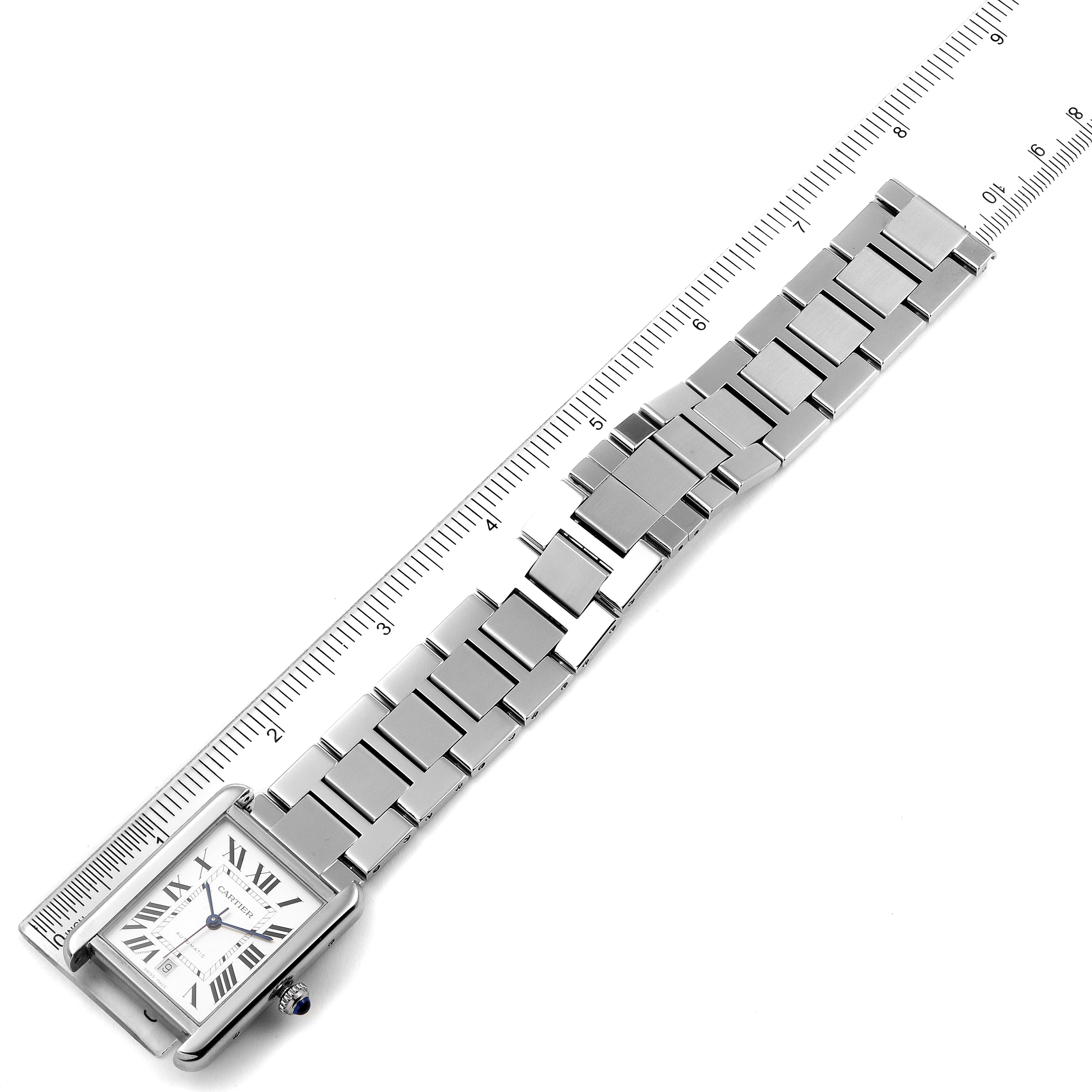 The Cartier Tank Solo W5200028 Men
s Stainless Steel Silver Dial W5200028 Men
s Stainless Steel Silver Dial watch is shown at an angled top view, focusing on its face and metal bracelet along with a ruler for measurement.