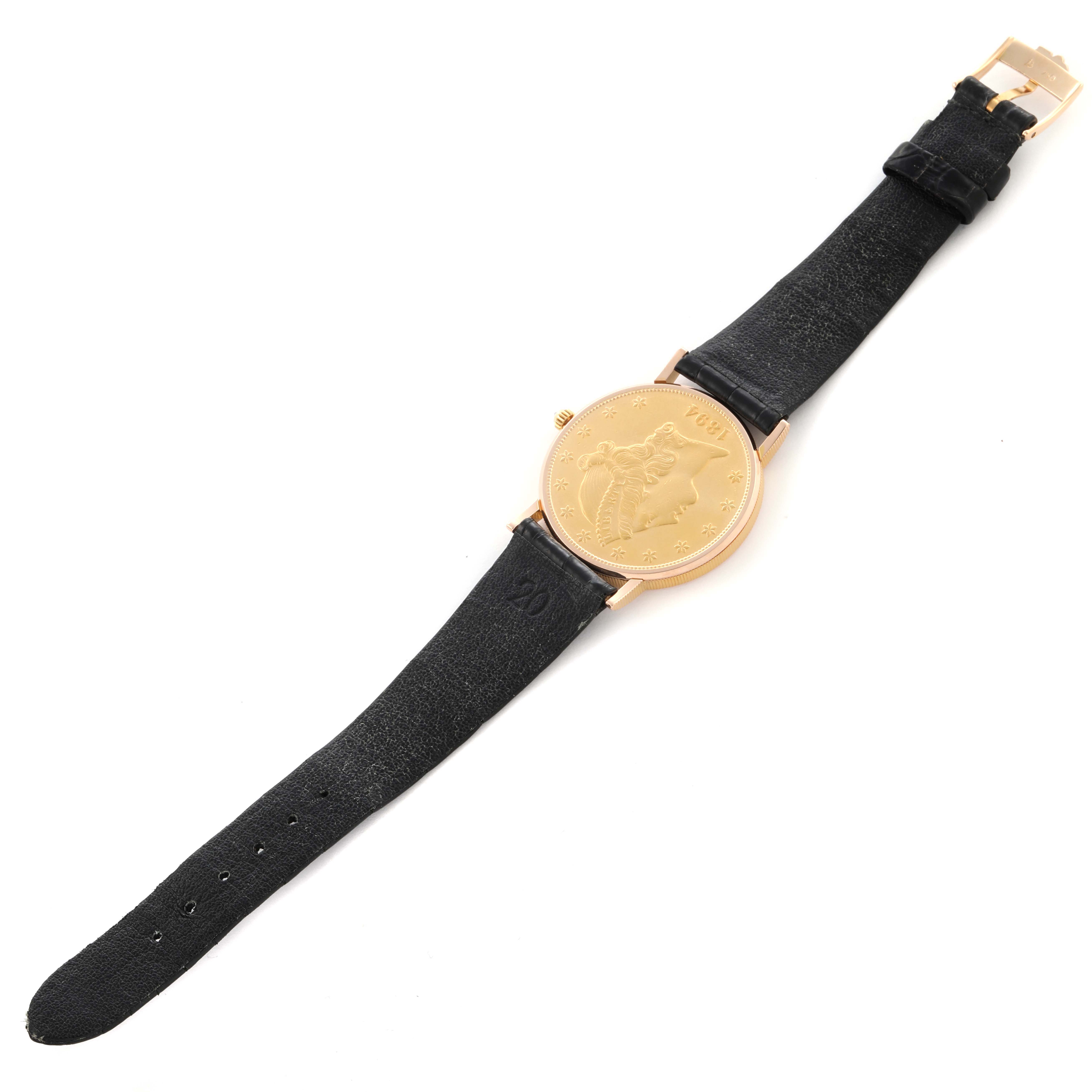 The Corum Coin Watch 1894 Men's Yellow Gold Champagne Dial 1894 Men's Yellow Gold Champagne Dial is shown at a slight angle displaying the coin face, case, crown, and black leather strap.
