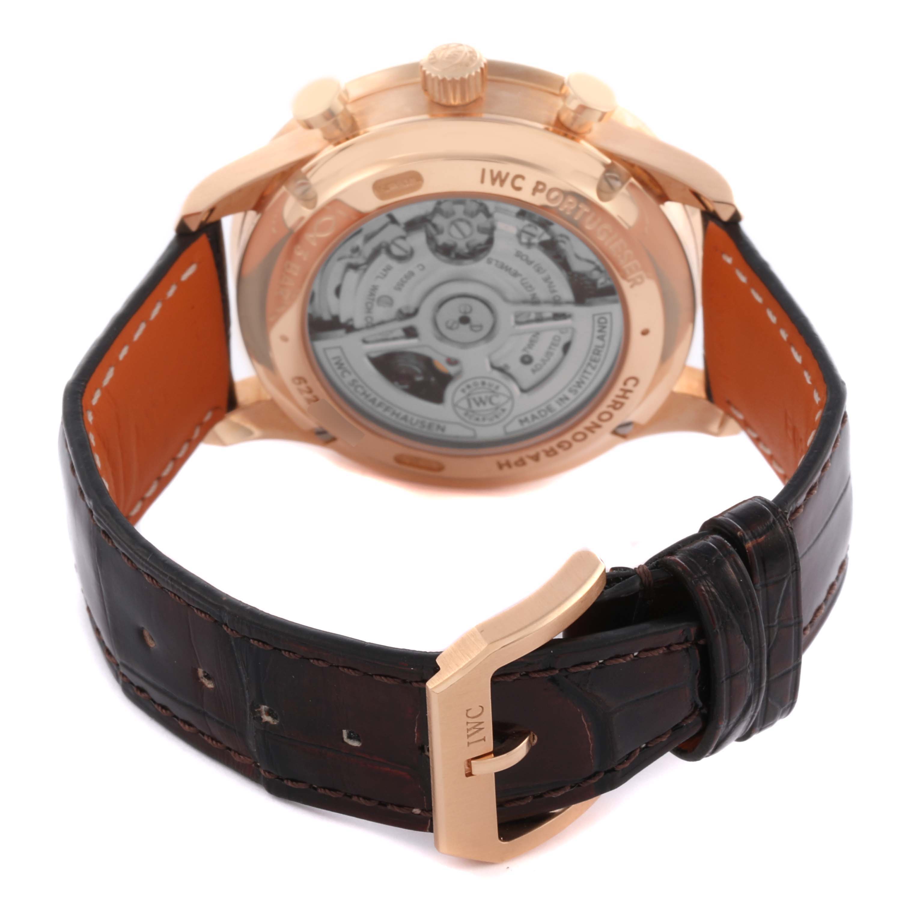 The image shows the back and side of an IWC Portuguese IW371611 Men's Rose Gold Silver Dial IW371611 Men's Rose Gold Silver Dial watch, highlighting its leather strap and exposed movement.