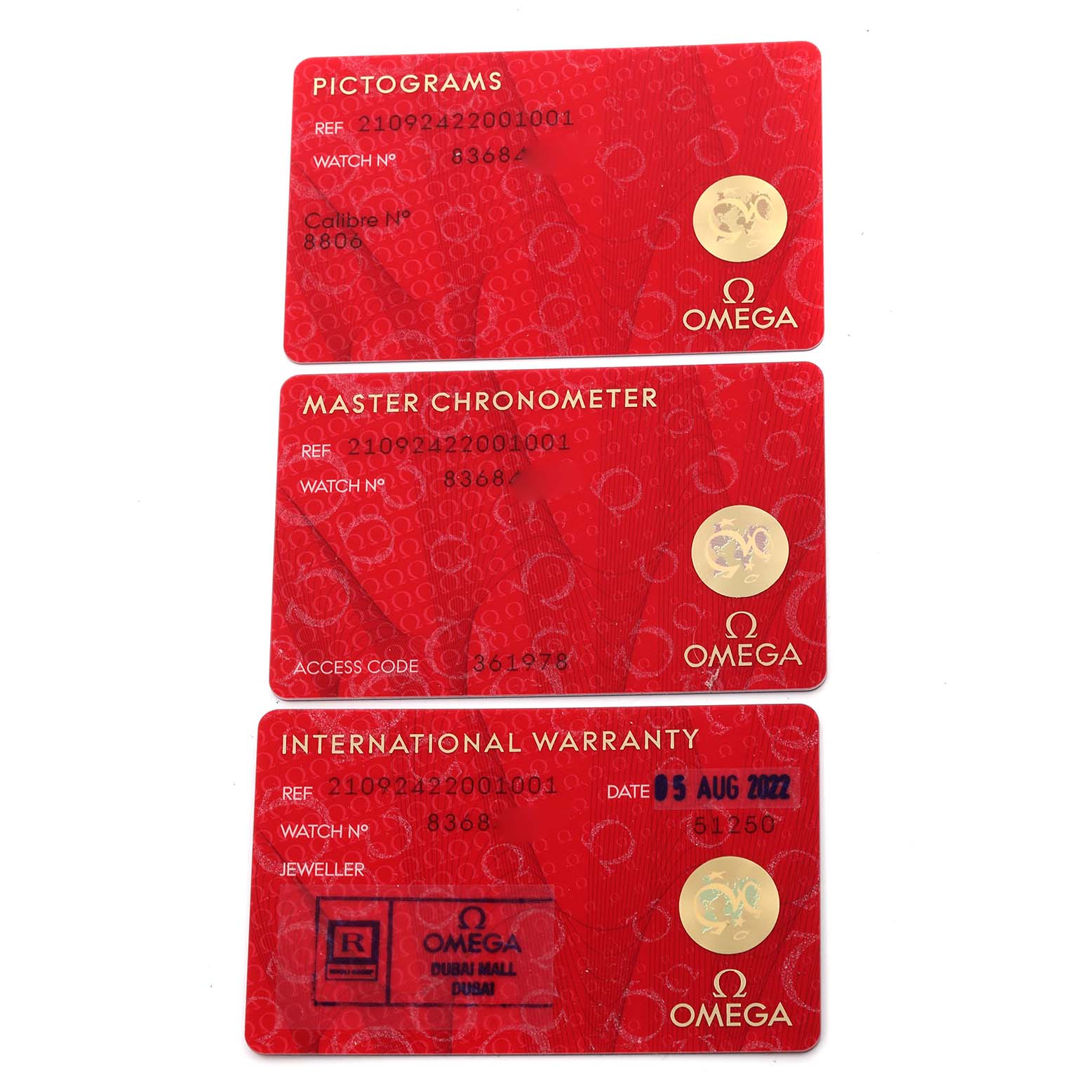 The image shows three warranty and certification cards for the Omega Seamaster 210.92.42.20.01.001 Men's Titanium Brown Dial 210.92.42.20.01.001 Men's Titanium Brown Dial watch.