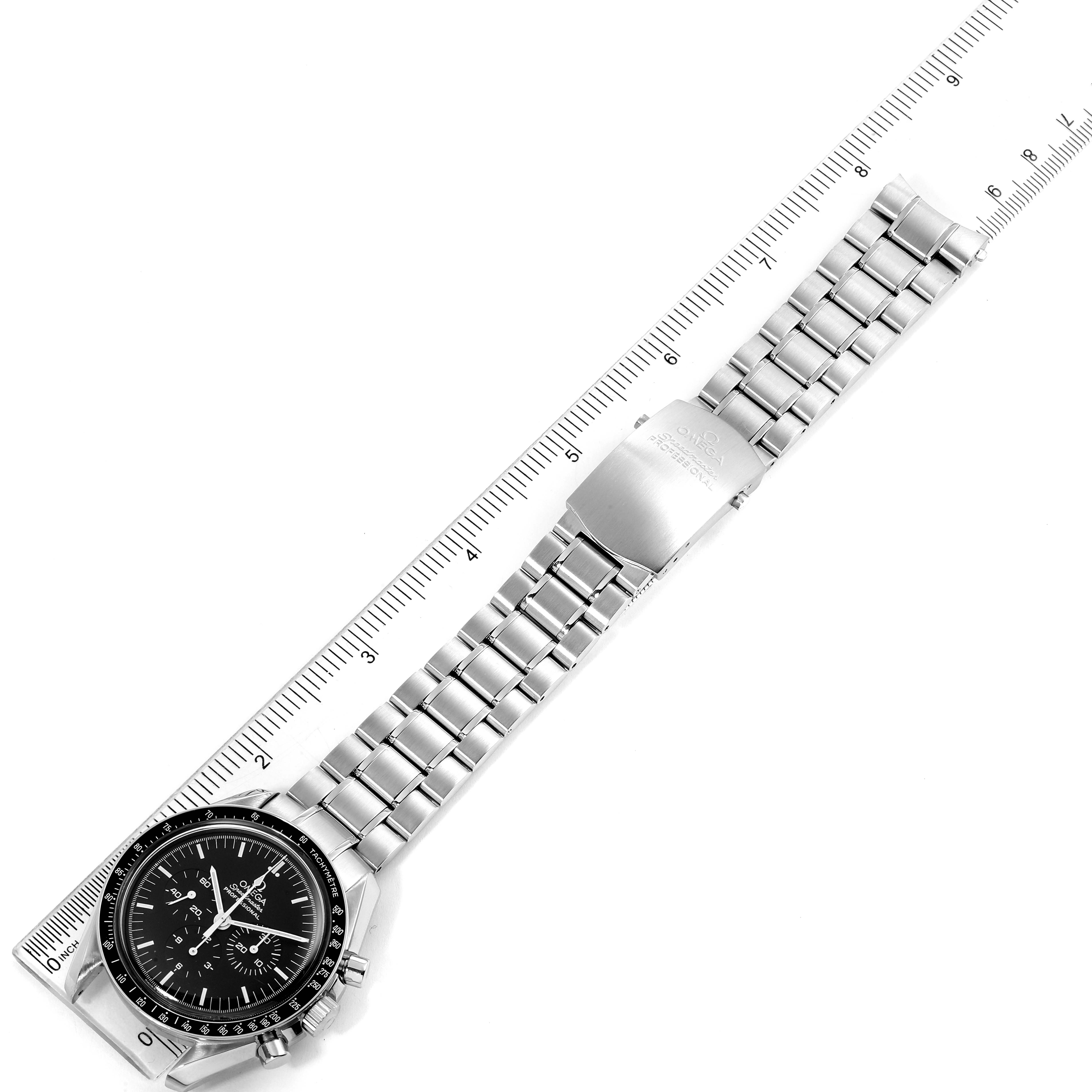 This image shows the Omega Speedmaster 3570.50.00 Men
s Stainless Steel Black Dial 3570.50.00 Men
s Stainless Steel Black Dial watch fully extended with its face and metal bracelet measured against a ruler.