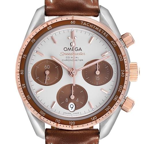 The Omega Speedmaster watch is shown from the front, highlighting the brown tachymeter bezel, subdials, and date window.