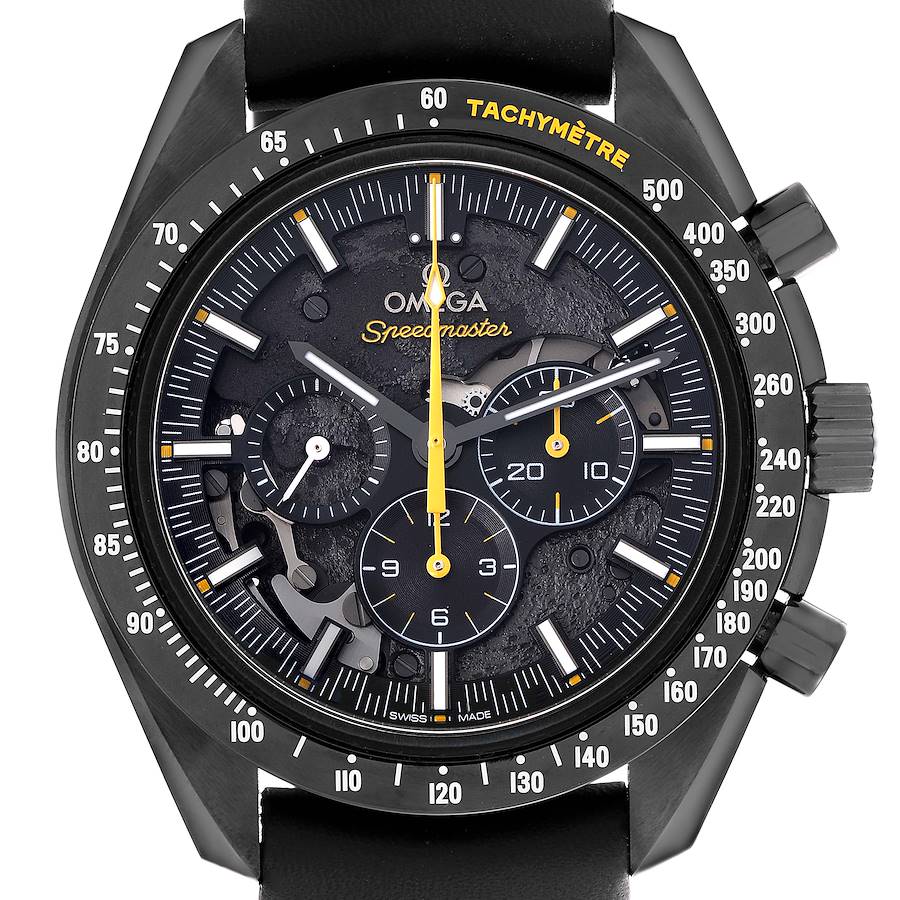 The Omega Speedmaster watch is shown from the front, highlighting the dial, tachymeter, and subdials.