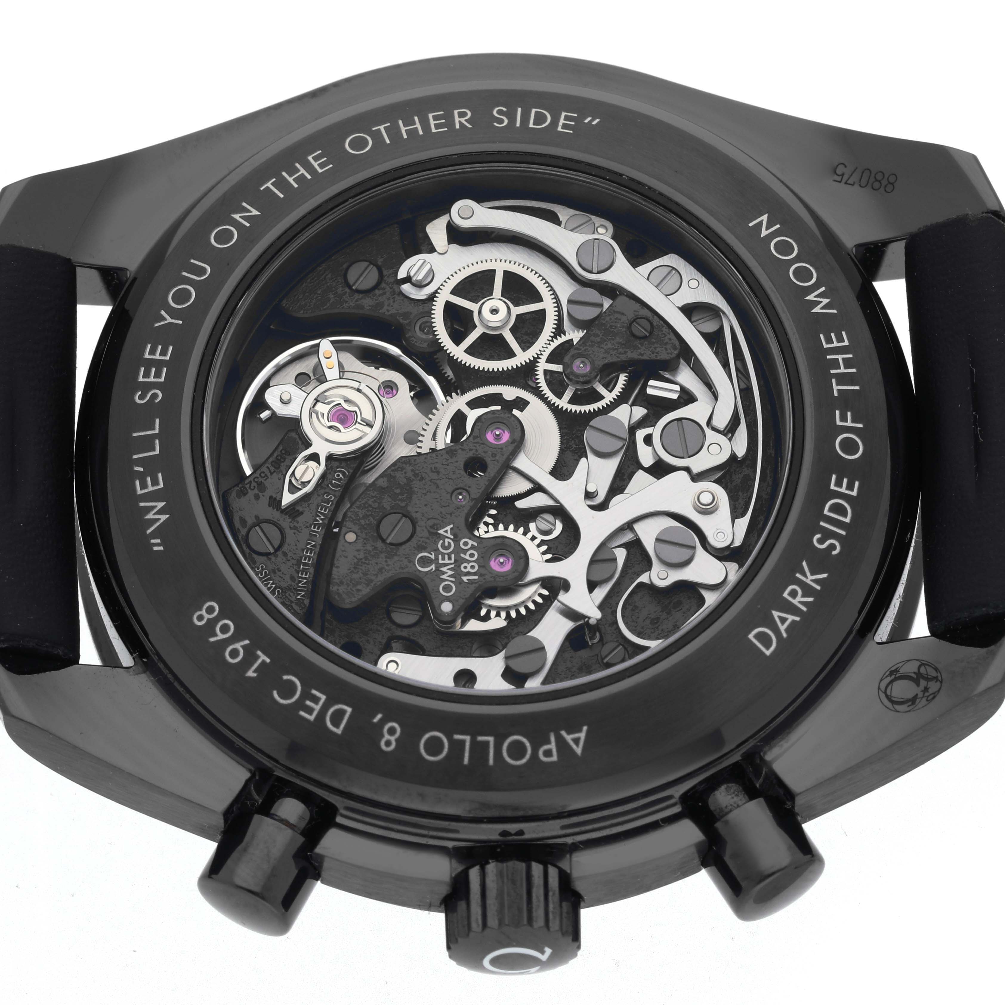 The image shows the back of an Omega Speedmaster 311.92.44.30.01.001 Men's Ceramic Black Dial 311.92.44.30.01.001 Men's Ceramic Black Dial watch, highlighting the intricate mechanics and inscriptions.