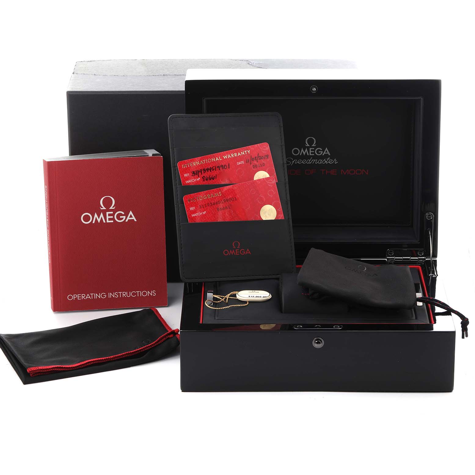 The Omega Speedmaster 311.93.44.51.99.001 Men's Ceramic Silver Dial 311.93.44.51.99.001 Men's Ceramic Silver Dial set includes a box, warranty cards, operating instructions, a protective pouch, and a tag, viewed from the front.