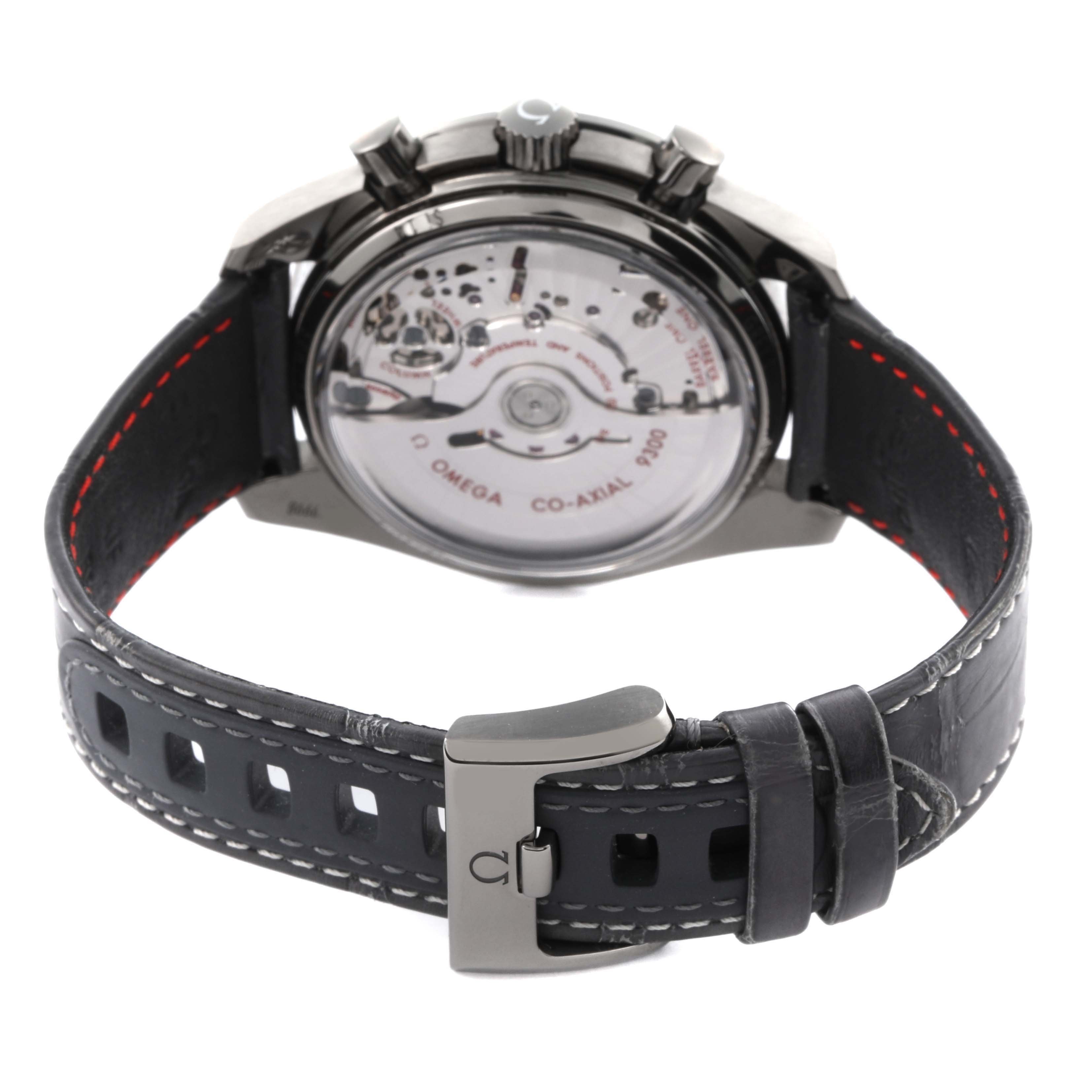 The Omega Speedmaster 311.93.44.51.99.001 Men's Ceramic Silver Dial 311.93.44.51.99.001 Men's Ceramic Silver Dial watch is shown from the back, highlighting its see-through case back and leather strap with a buckle.