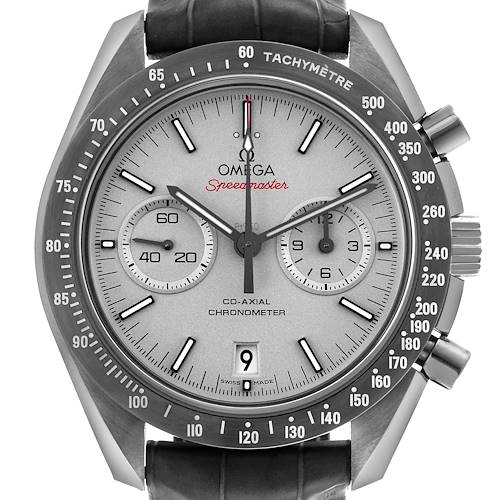 The Omega Speedmaster watch is shown from a front angle, displaying the dial, tachymetric bezel, subdials, and pushers.