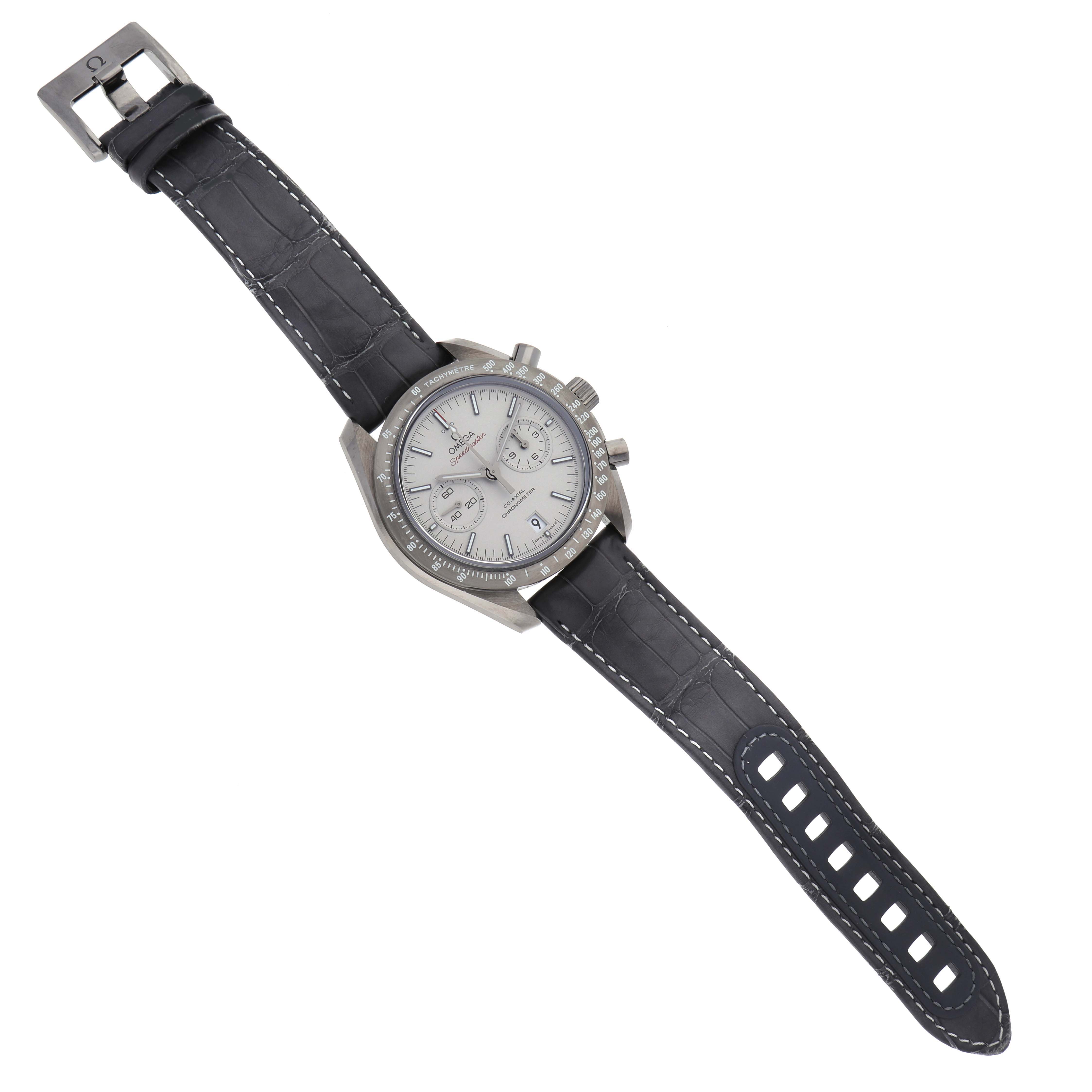 The Omega Speedmaster 311.93.44.51.99.001 Men's Ceramic Silver Dial 311.93.44.51.99.001 Men's Ceramic Silver Dial watch is shown from a top-down angle, displaying the dial, bezel, case, and full strap with buckle.