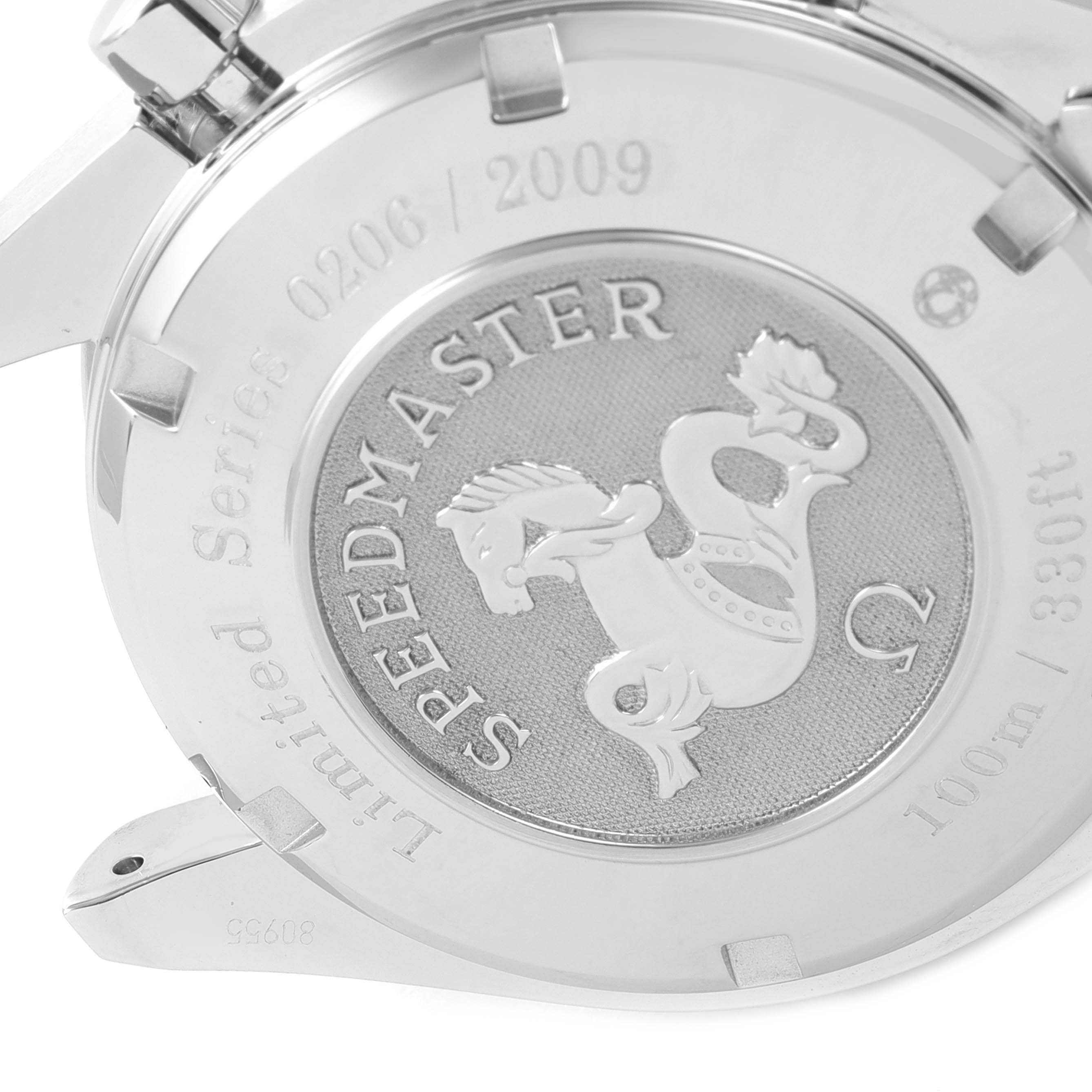 The image shows the back case of an Omega Speedmaster 323.30.40.40.02.001 Men's Stainless Steel White Dial 323.30.40.40.02.001 Men's Stainless Steel White Dial watch, detailing the engraving and model information at a close-up angle.