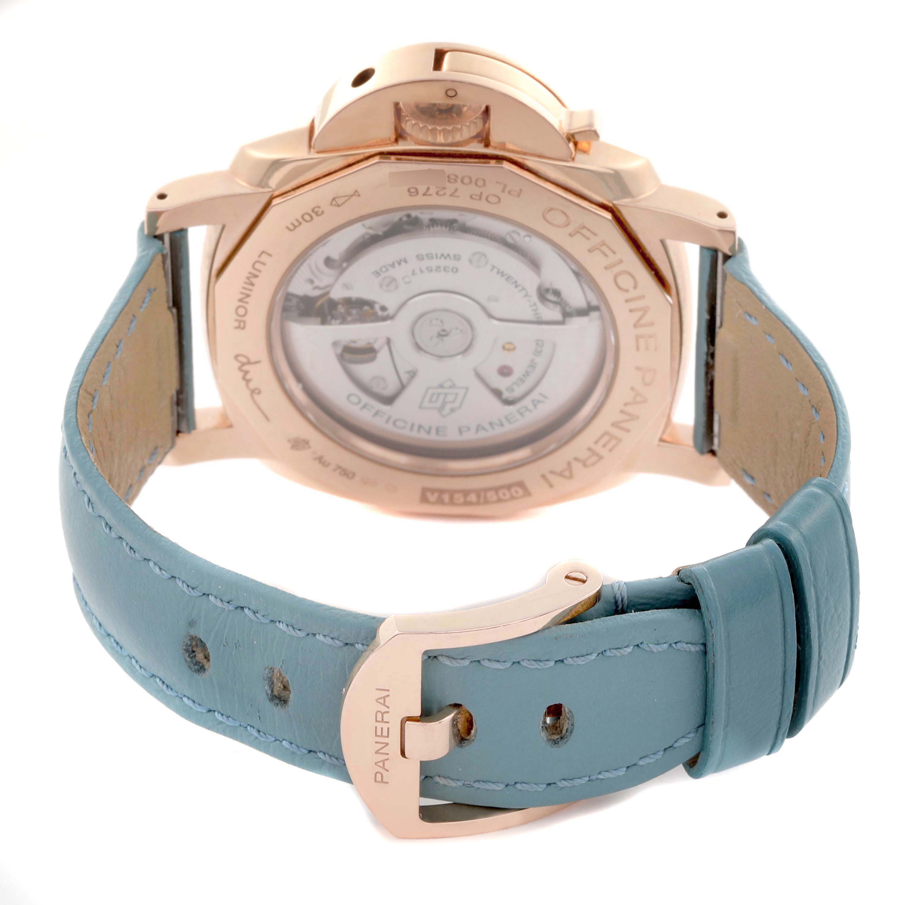 The image shows the back of a Panerai Luminor PAM01042 Men's Rose Gold White Dial PAM01042 Men's Rose Gold White Dial watch, highlighting the movement through the sapphire case back, and a turquoise strap.