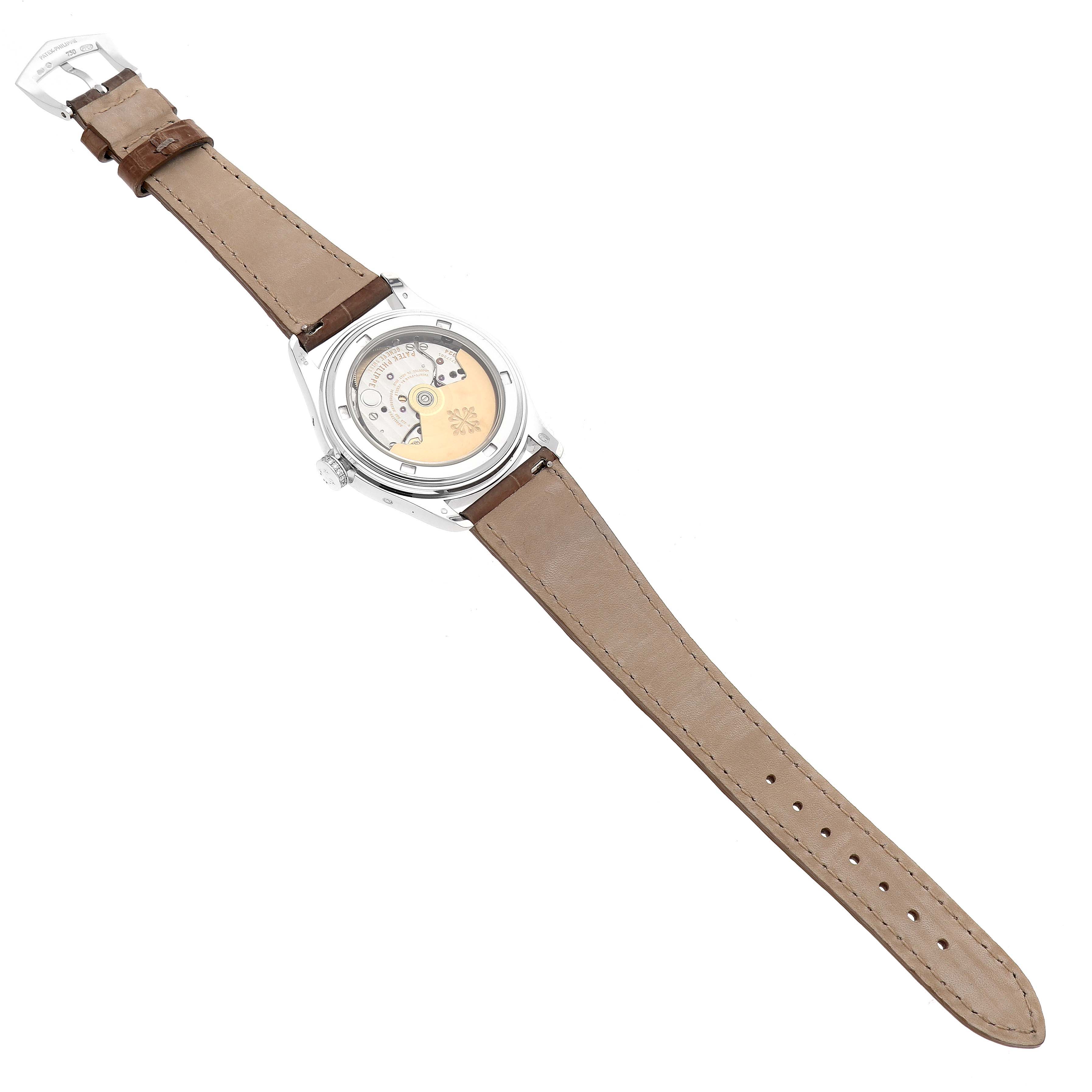 The image shows the back view of a Patek Philippe Complications 4936 Men's White Gold Mother of Pearl Dial watch, highlighting its movement and light brown leather strap.