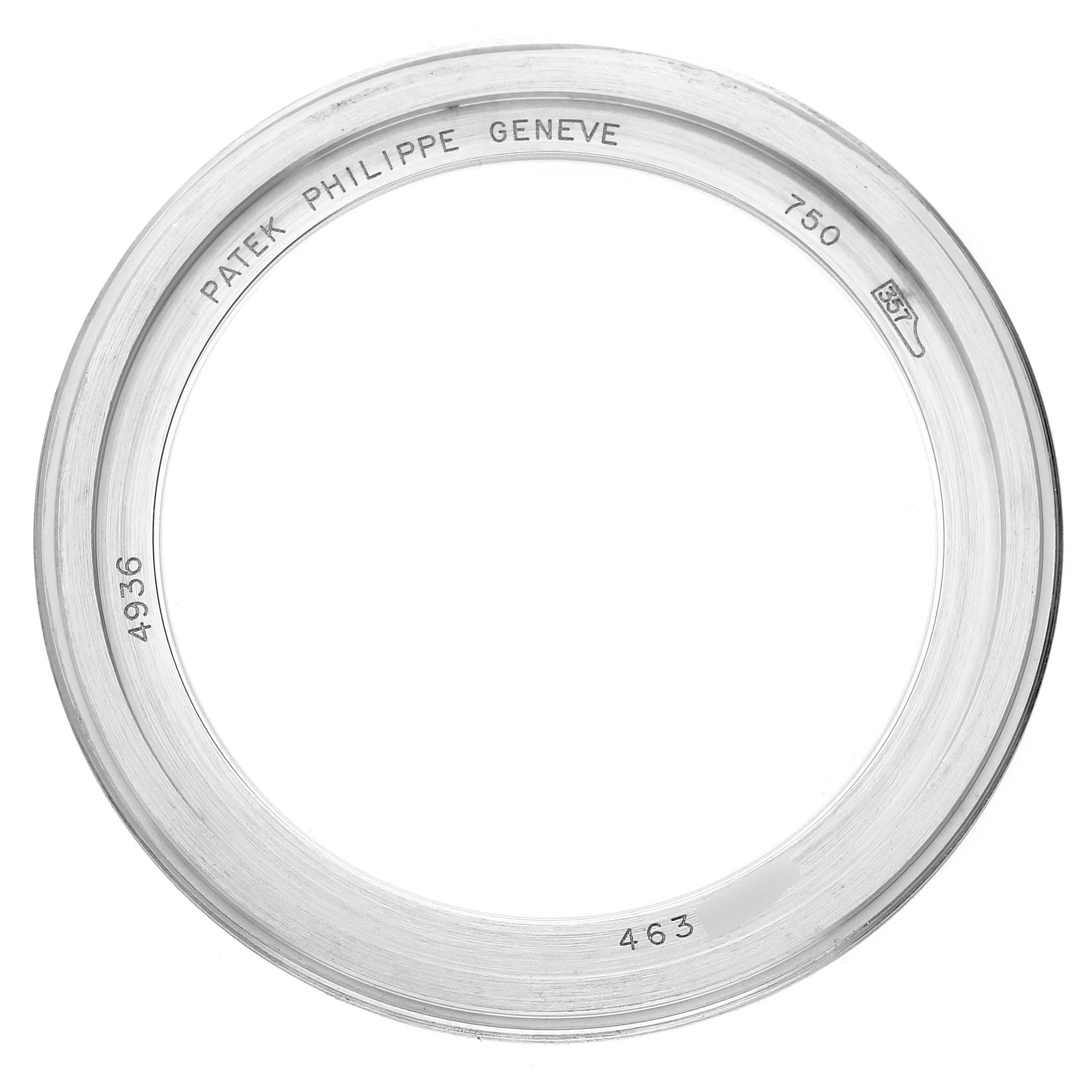 This image shows a Patek Philippe Complications 4936 Men's White Gold Mother of Pearl Dial model bezel from a top-down perspective, featuring engraved details.