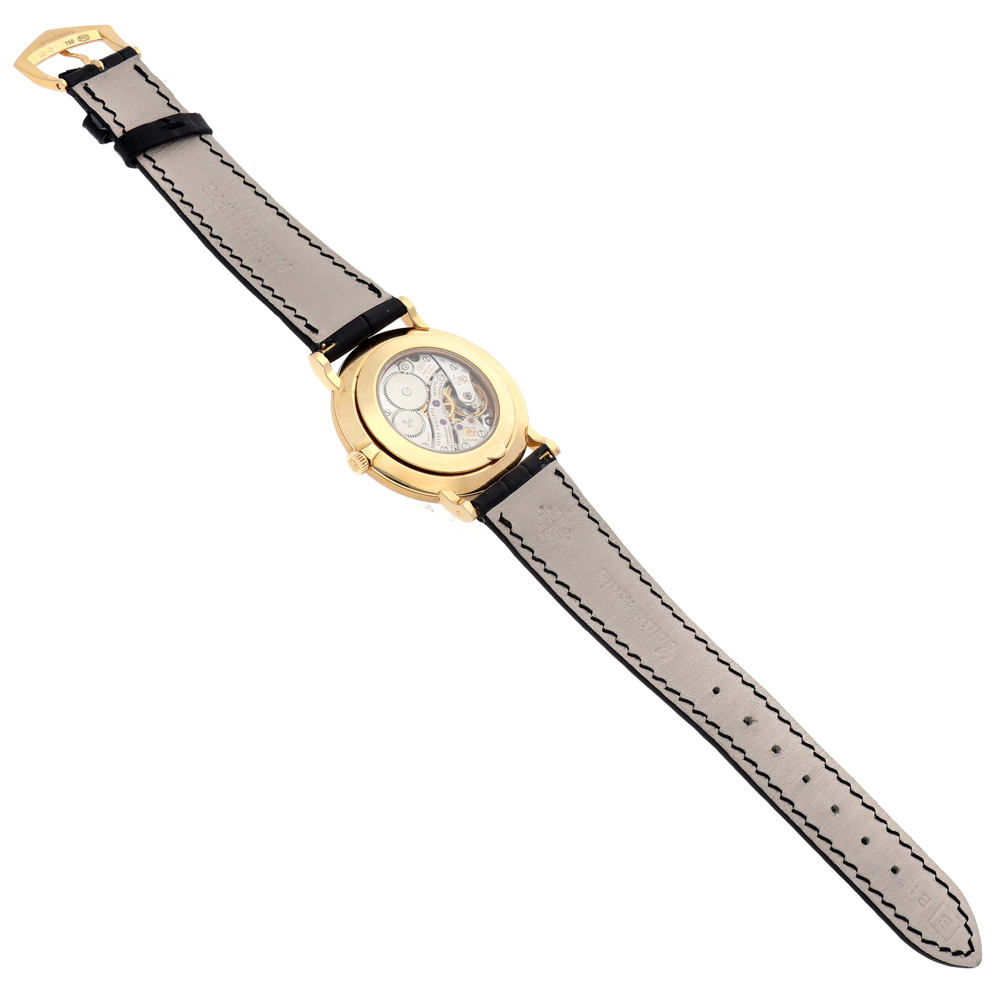The Patek Philippe Calatrava 5119J Men's Yellow Gold White Dial 5119J Men's Yellow Gold White Dial watch is shown from an angled side view, displaying its leather strap and gold case with a visible mechanical back.