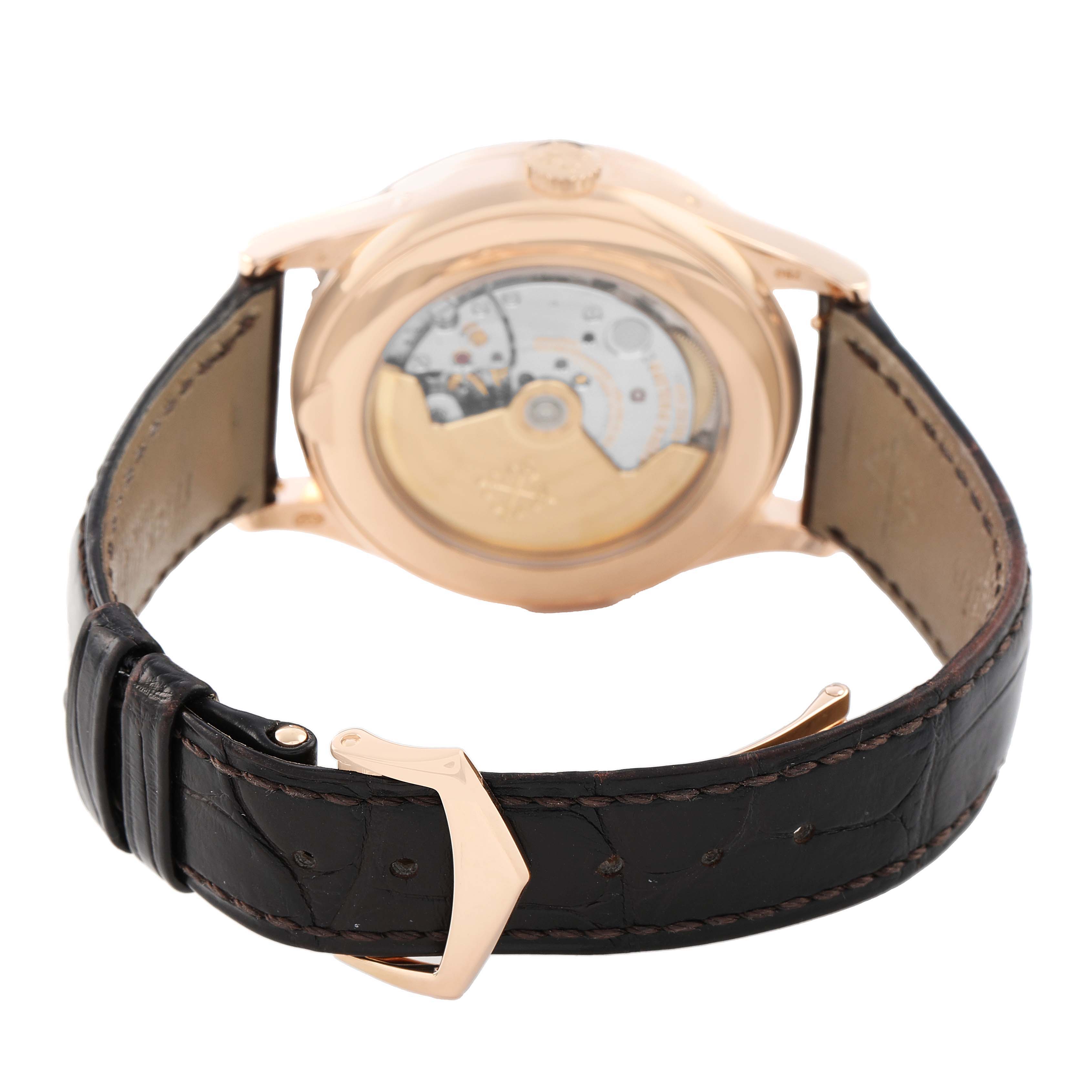 The image shows the Patek Philippe Complications 5396R-001 Men's Rose Gold Silver Dial watch from the rear, highlighting the transparent case back and leather strap.