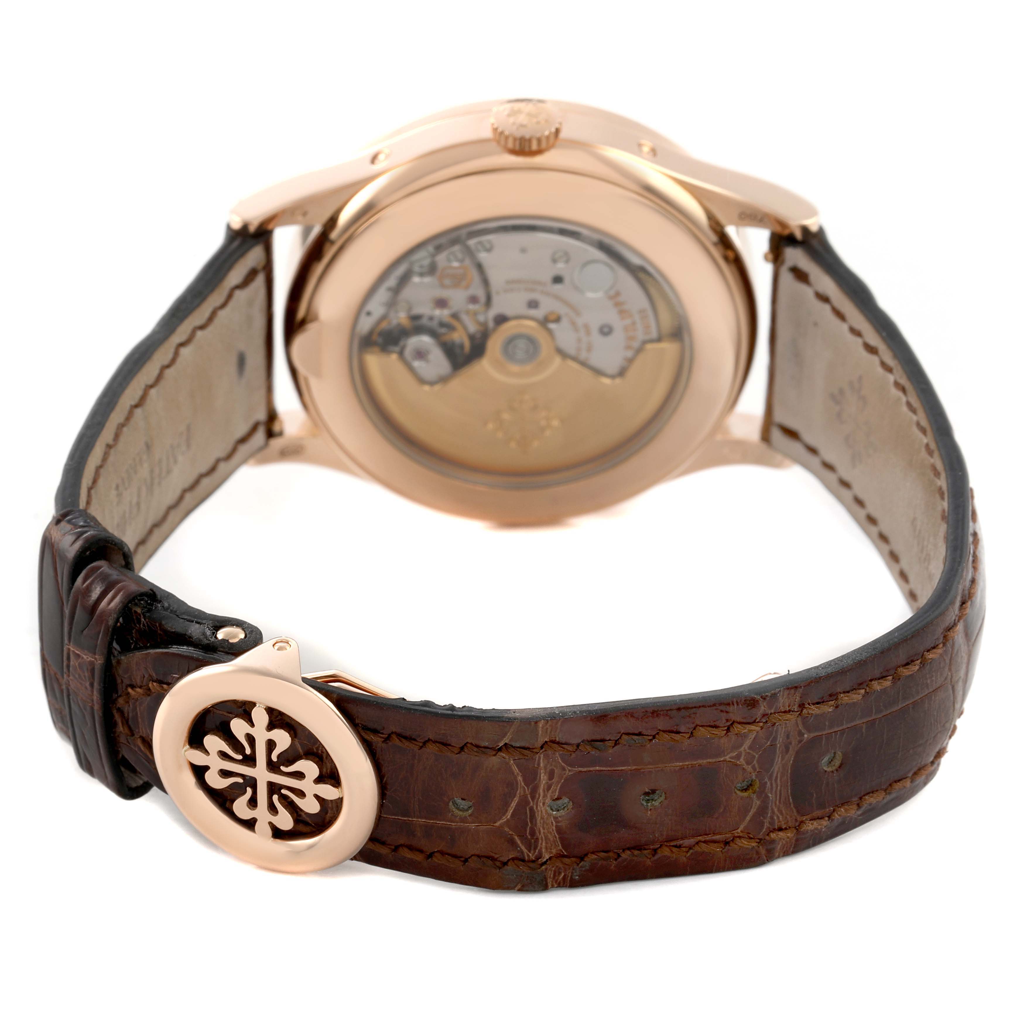 The Patek Philippe Complications 5396R Men's Rose Gold Silver Dial watch is shown from the back, highlighting the transparent case back and leather strap with clasp.