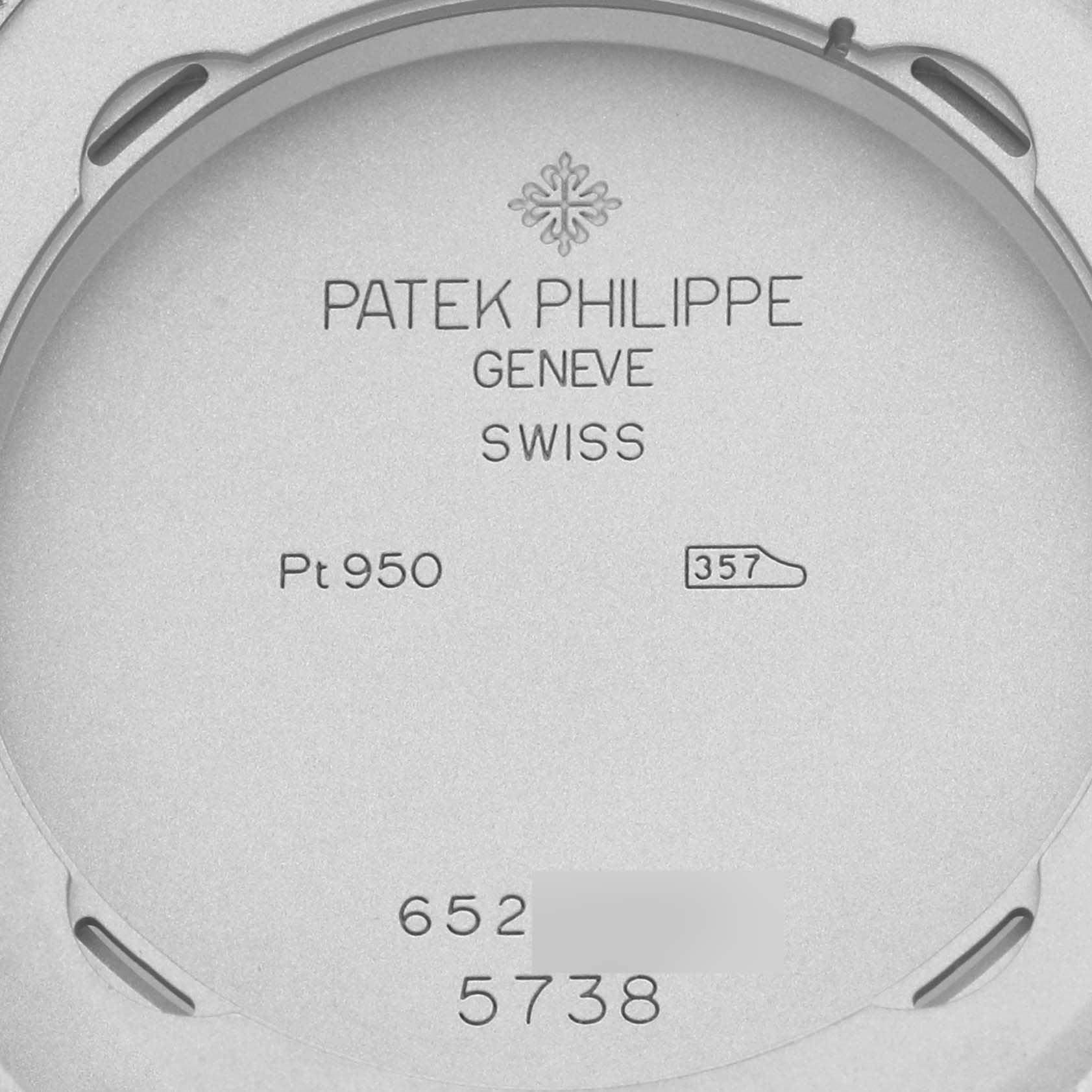 The image shows the engraved back of a Patek Philippe Golden Ellipse 5738P-001 Men's Platinum Blue Dial 5738P-001 Men's Platinum Blue Dial watch, displaying the brand, model information, and material details.