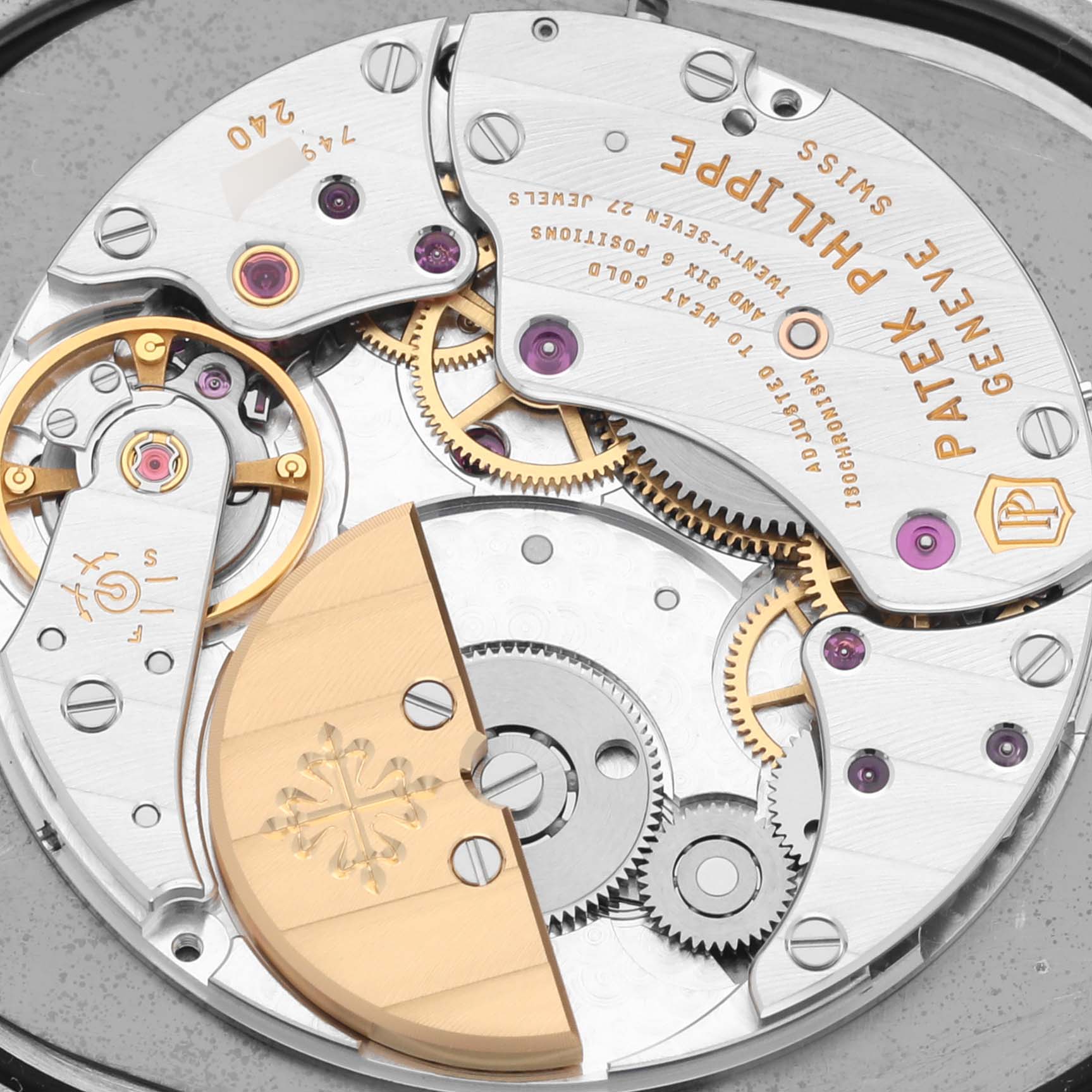 The image shows the movement of a Patek Philippe Golden Ellipse 5738P-001 Men's Platinum Blue Dial 5738P-001 Men's Platinum Blue Dial watch, highlighting gears and the rotor from a top-down angle.