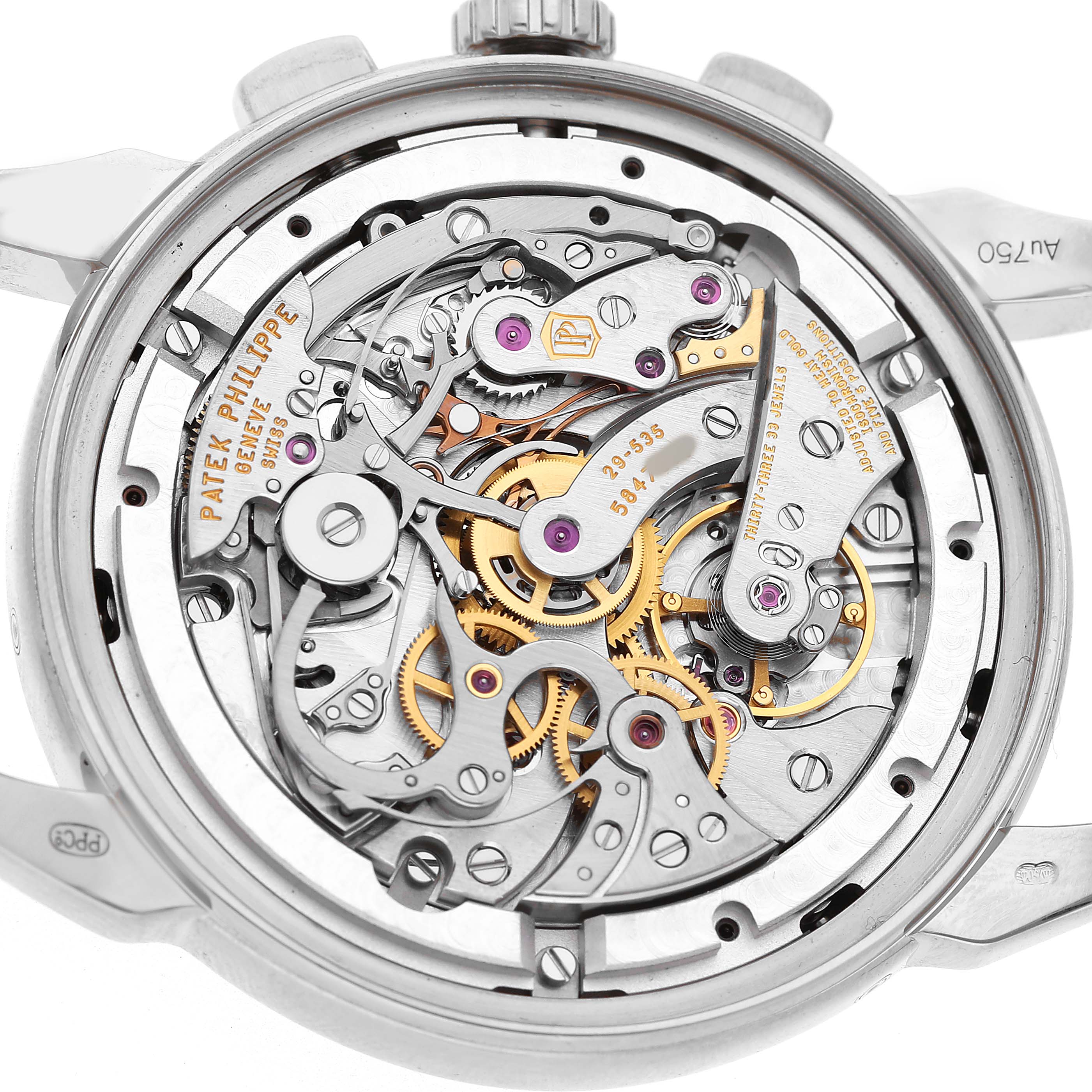 The image shows the back view of the Patek Philippe Complications 5270 Men's White Gold Silver Dial watch, highlighting its intricate movement and gears.