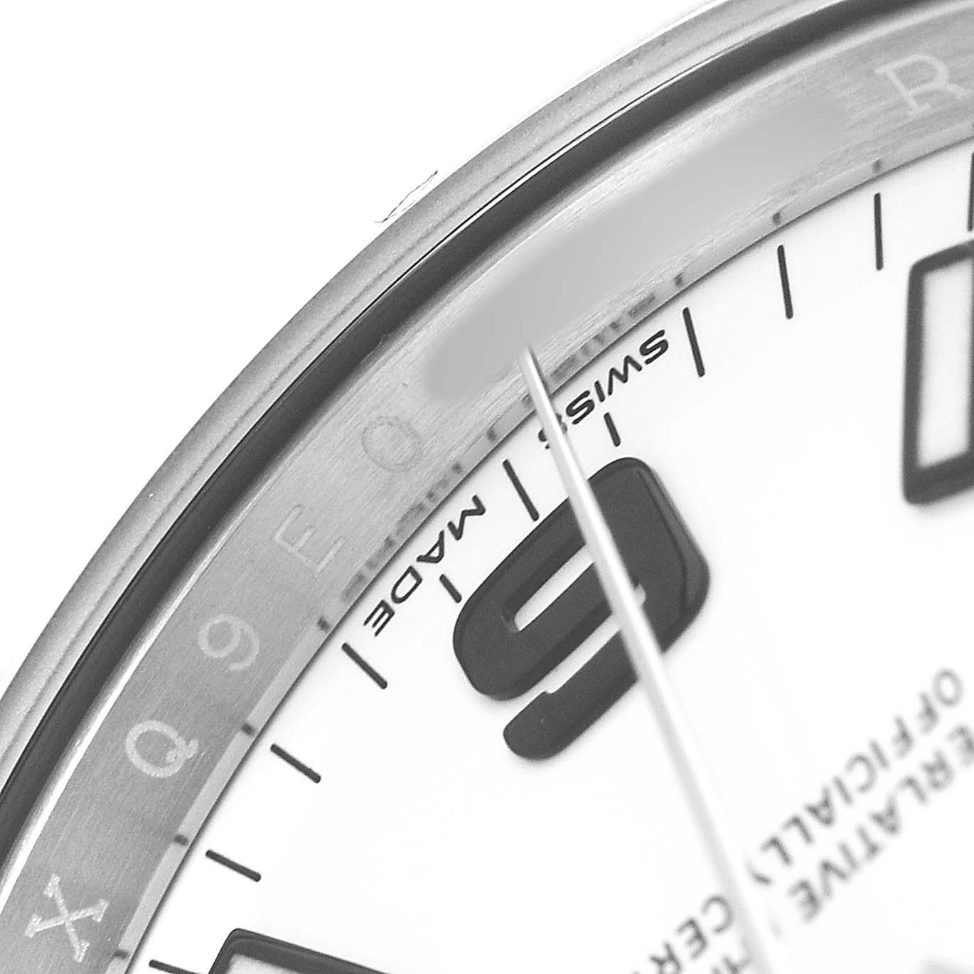 This close-up image of the Rolex Air-King 114200 Men's Stainless Steel White Dial shows part of the dial, focusing on the "9" marker and "Swiss Made" text.