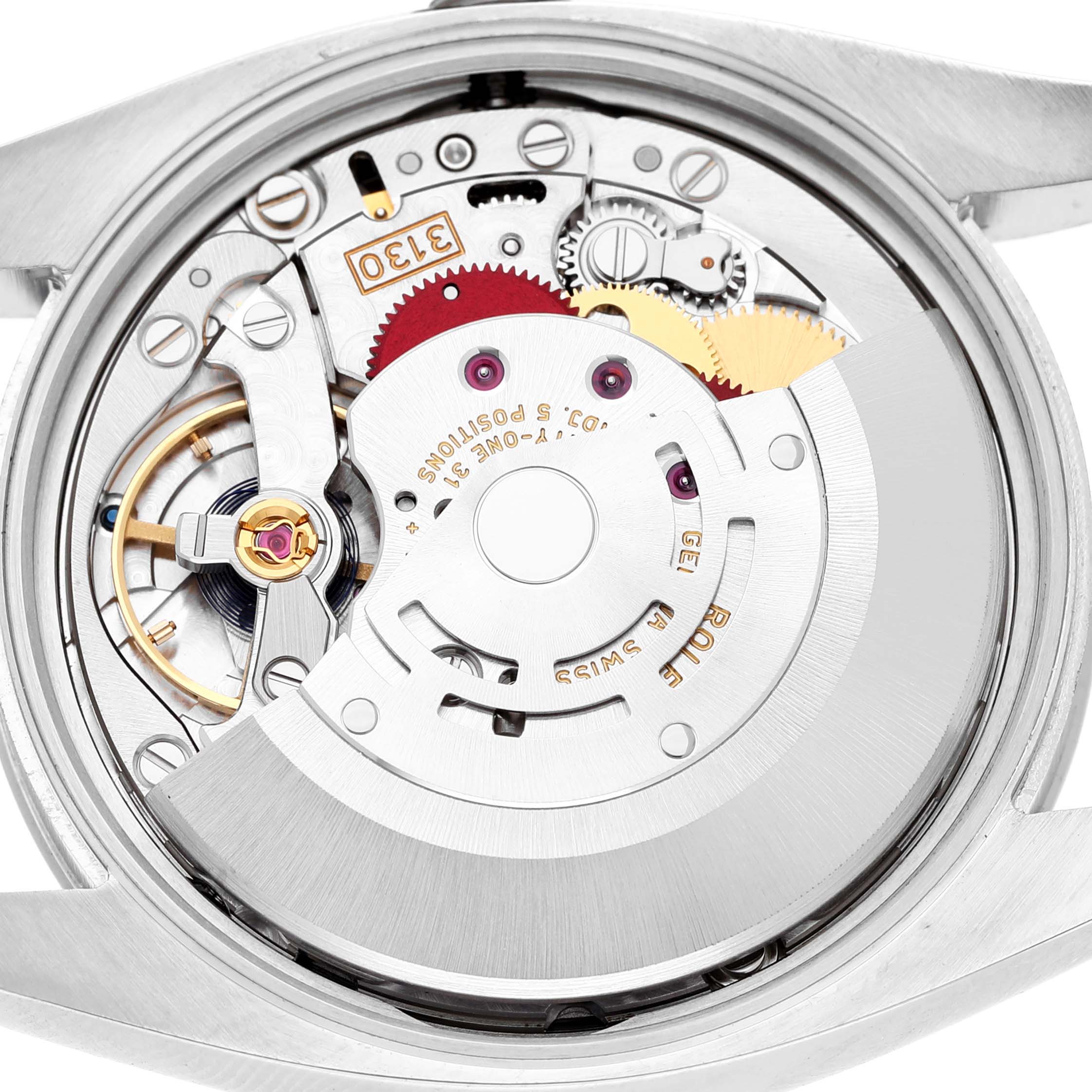 The image shows the back view of a Rolex Air-King 114200 Men's Stainless Steel White Dial watch, highlighting its movement and internal mechanical components.
