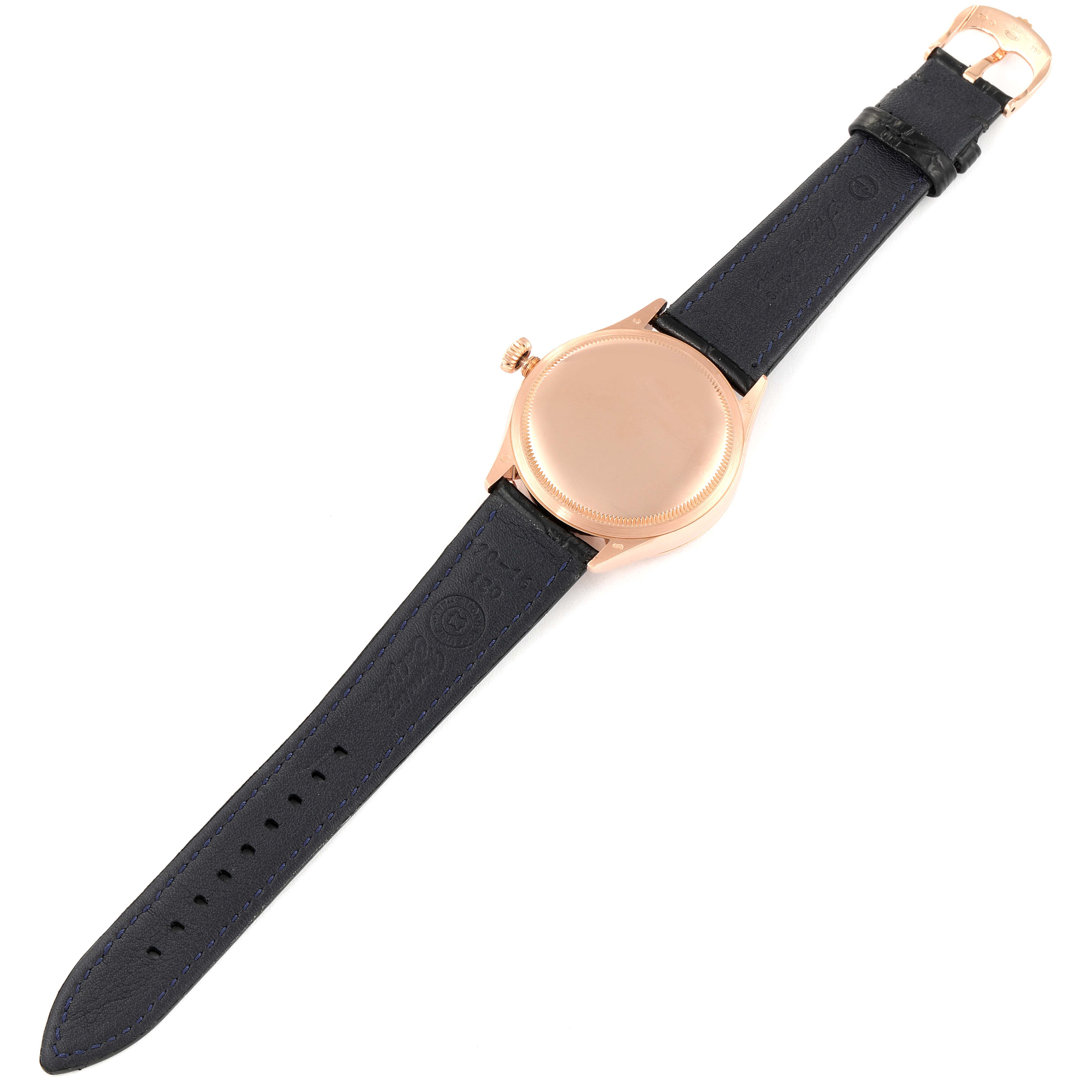 This image shows the underside of the Rolex Cellini 50525 Men's Rose Gold Black Dial 50525 Men's Rose Gold Black Dial watch, featuring its case back, crown, and leather strap.