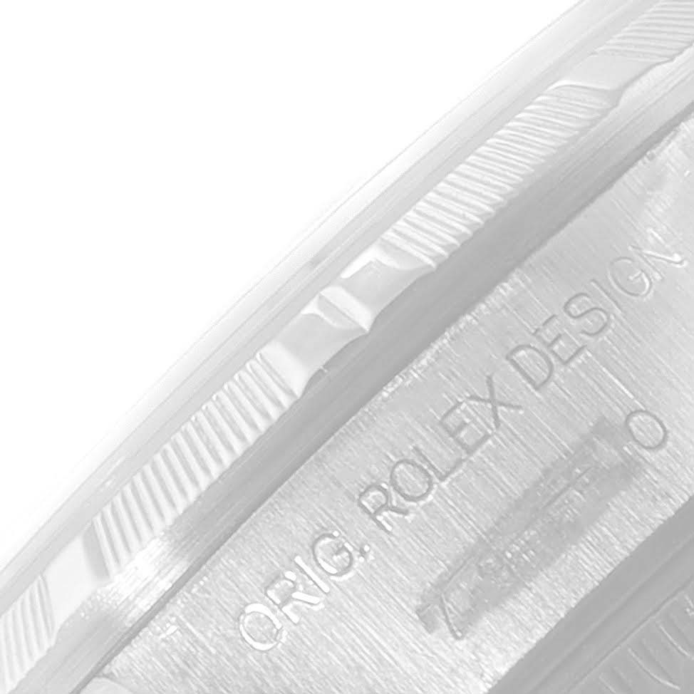 This image shows a close-up of the fluted bezel and engraved case side of a Rolex Date 79190 Women
s Stainless Steel Blue Dial 79190 Women
s Stainless Steel Blue Dial model watch.