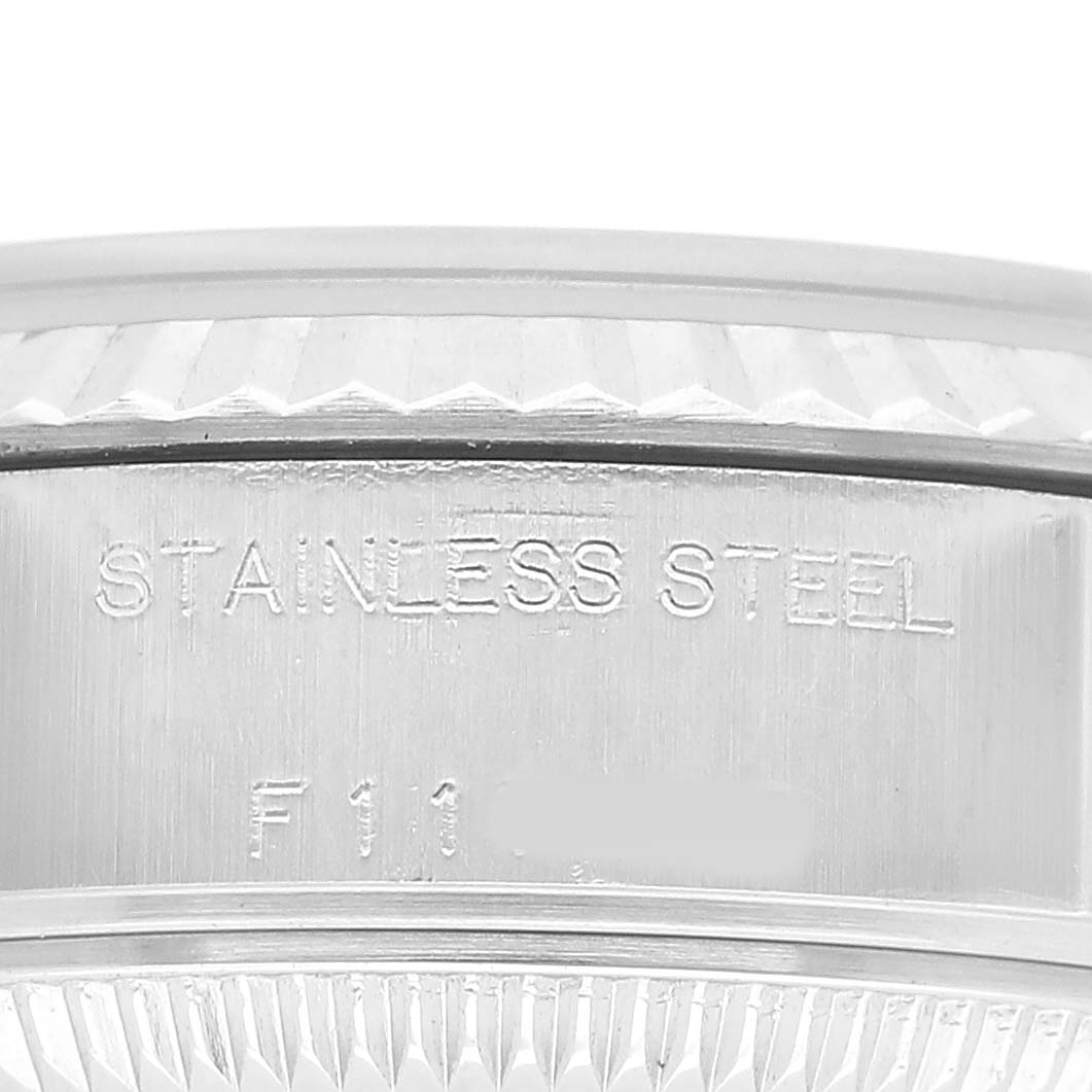 The image shows the side view of a Rolex Datejust 79174 Women's Stainless Steel Silver Dial watch case, highlighting "STAINLESS STEEL" engraving.