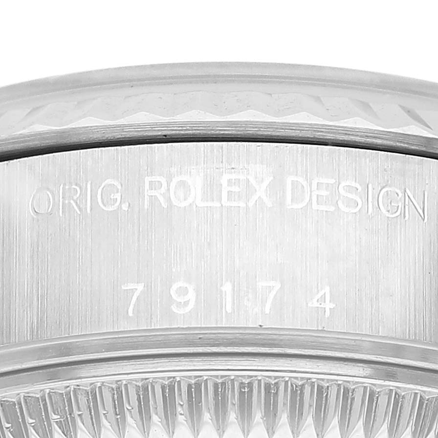 The image shows the side engraving and fluted bezel of a Rolex Datejust 79174 Women's Stainless Steel Silver Dial watch.