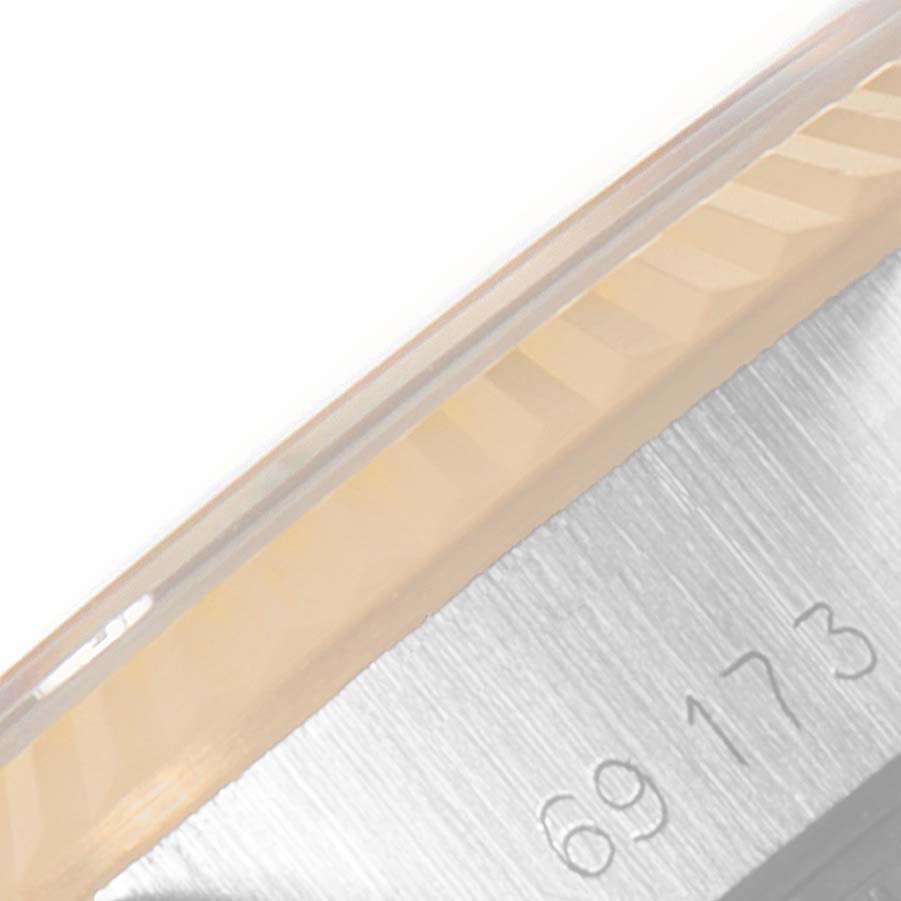 This image shows a close-up of the side of a Rolex Datejust 69173 Women
s Steel and Gold (two tone) Champagne Dial 69173 Women
s Steel and Gold (two tone) Champagne Dial watch, focusing on the bezel and part of the serial number engraving.
