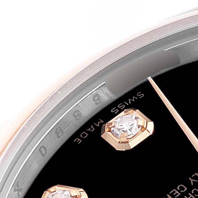 This image shows a close-up of the dial and bezel of a Rolex Mid-Size 178241 Women
s Steel and Gold (two tone) Black Dial 178241 Women
s Steel and Gold (two tone) Black Dial watch, highlighting the "Swiss Made" text and a diamond marker.