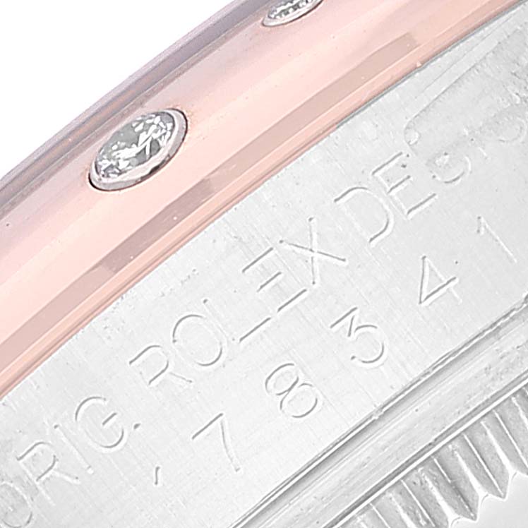 The close-up image shows the bezel and engraved side of the case of a Mid-Size Rolex watch, featuring a pink band with embedded diamonds.