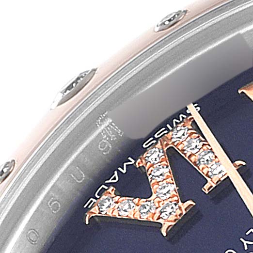 The image shows a close-up of the dial and bezel of a Rolex Mid-Size 178341 Women's Steel and Gold (two tone) Purple Dial 178341 Women's Steel and Gold (two tone) Purple Dial watch, highlighting jeweled Roman numeral markers and part of the bezel screws.