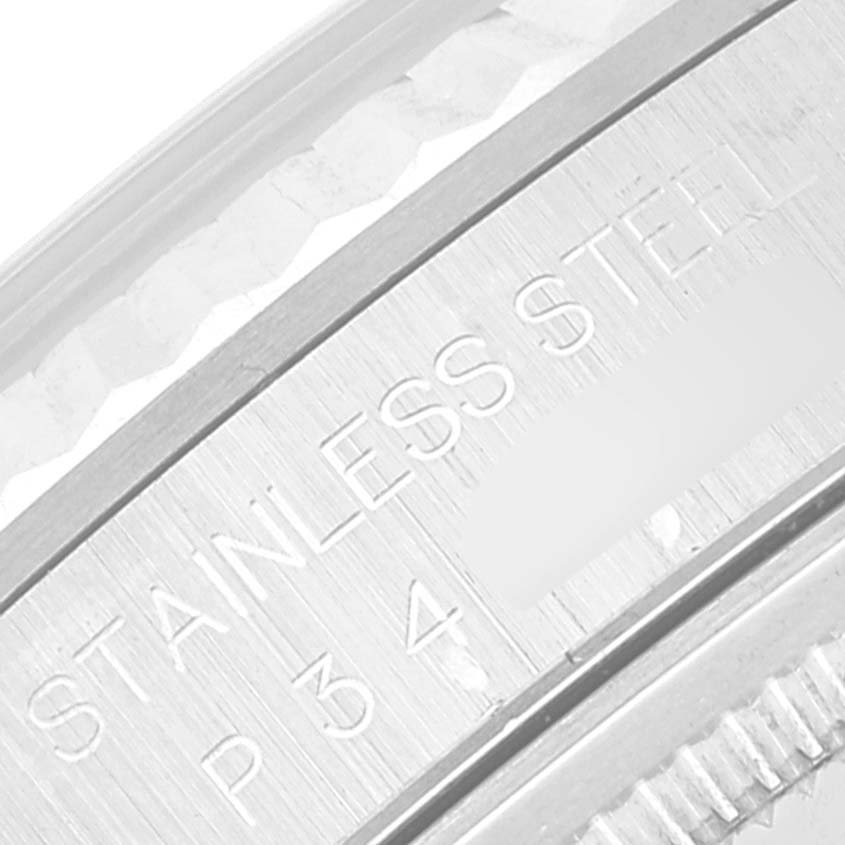 This close-up image shows the engraved stainless steel area and fluted bezel of the Datejust model by Rolex.