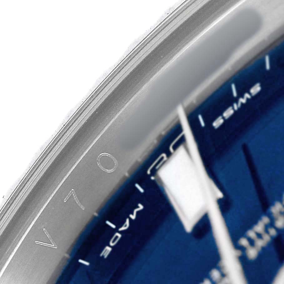 The image shows a close-up of the bezel and part of the dial of a Rolex Datejust 41 116334 Men's Stainless Steel Blue Dial watch, highlighting the engraved details.