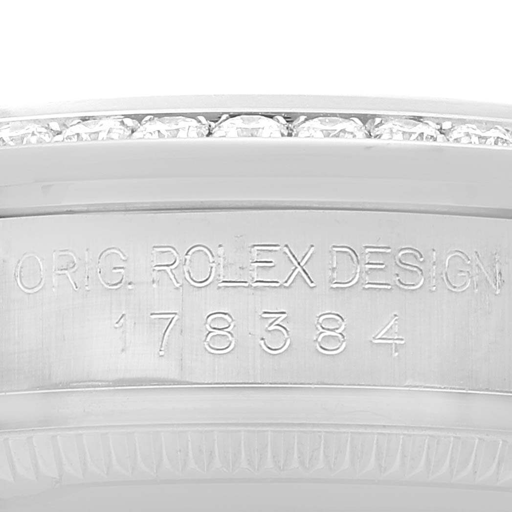 This image shows a close-up angle of the side engraving and bezel with diamonds on the Rolex Mid-Size 178384 Women's Stainless Steel Brown Dial 178384 Women's Stainless Steel Brown Dial model.