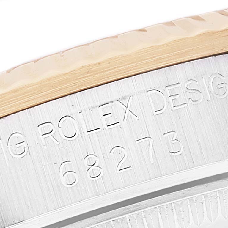 The image shows an engraved side view of a Rolex Mid-Size 68273 Women
s Steel and Gold (two tone) White Dial 68273 Women
s Steel and Gold (two tone) White Dial model, featuring part of its bezel and case with the model number 68273.